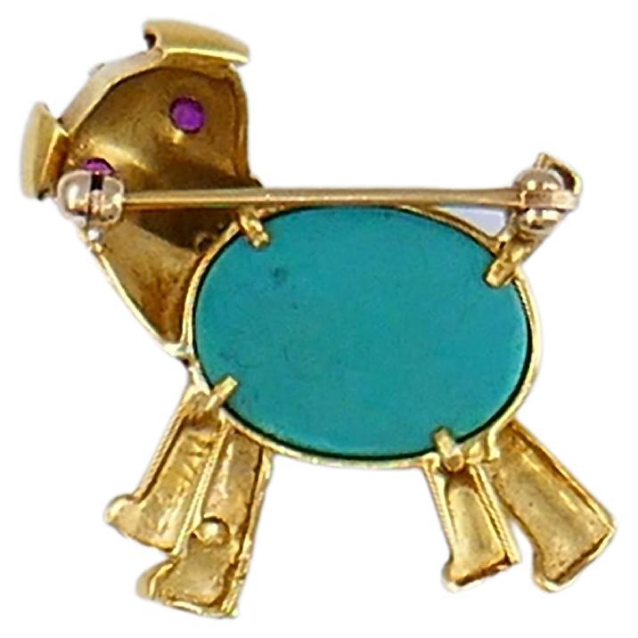 A charming dog pin from the Retro era; made of 14k gold, featuring gemstones. This vintage dog brooch carries amazing craftsmanship and artistic flair of the era. It’s a playful and fun piece. The dog’s eyes are accented with rubies, the nose
