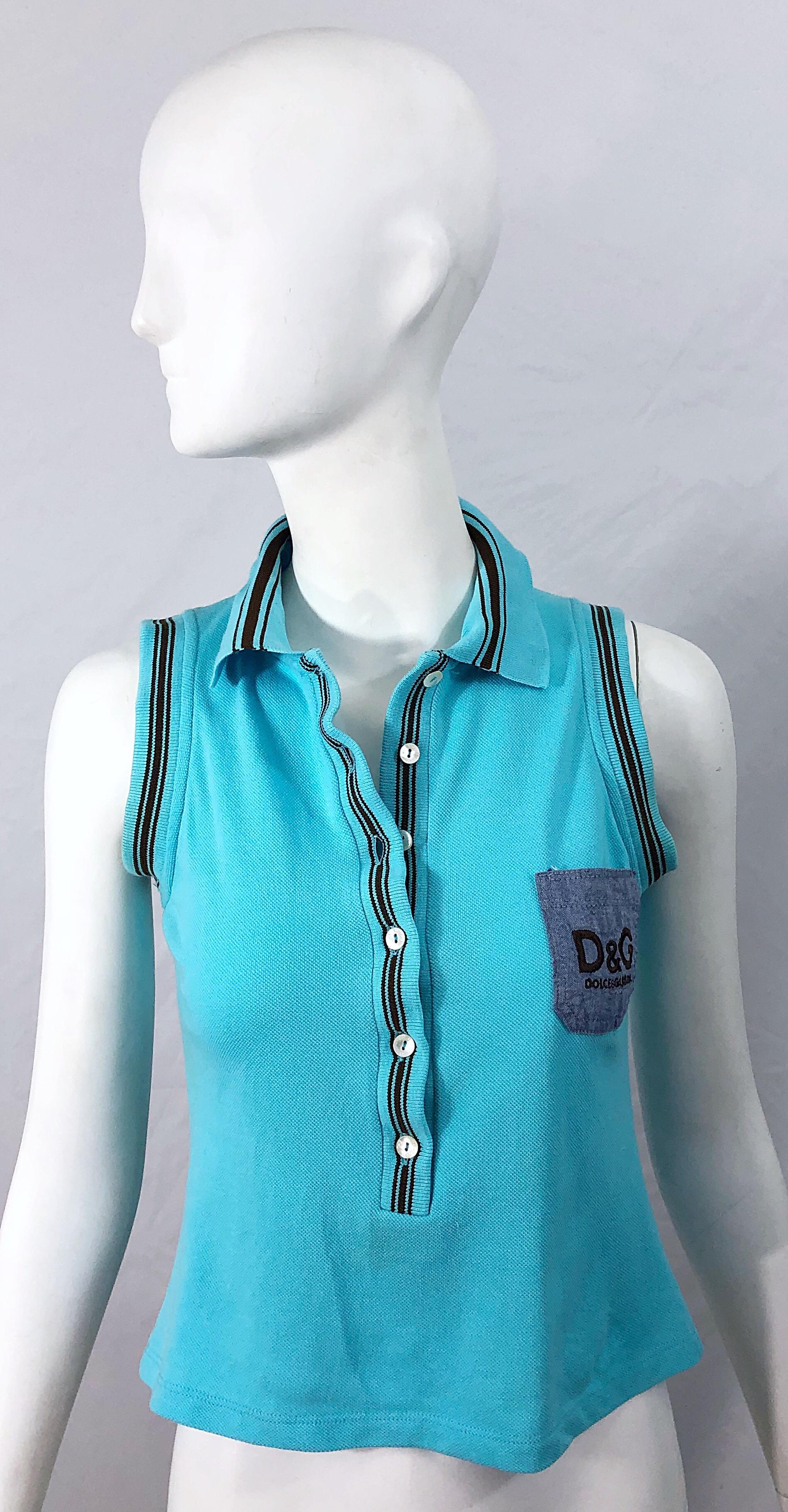 Stylish late 1990s DOLCE AND GABBANA turquoise blue and brown logo knit crop top ! Features a soft cotton knit with a chambray denim pocket patch at left breast with D&G embroidered in brown. Buttons up the front. 
In great condition
Made in