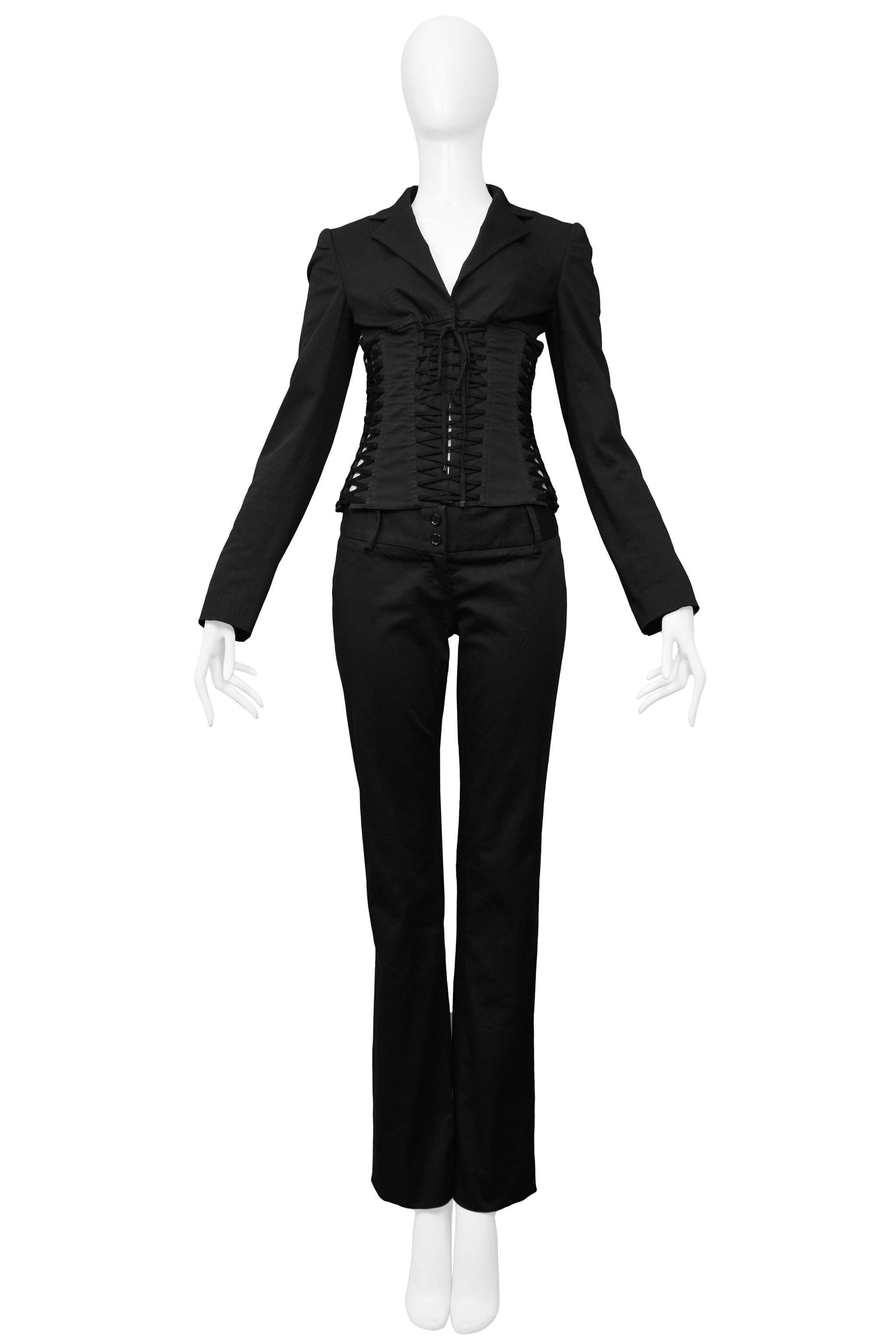 Resurrection Vintage is excited to offer a vintage Dolce & Gabbana black cotton suit featuring a blazer with a laced corset bodice, back zipper closure, notched lapel and button cuffs. The matching boot cut pants feature a wide waistband with double