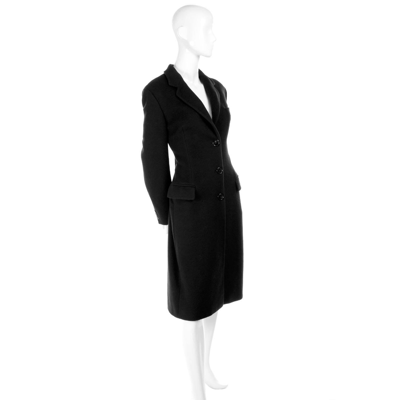 This is a lovely, soft midnight cashmere coat from Dolce & Gabbana. The coat is lined in Dolce & Gabbana monogram silk and has two front flap pockets and one faux front breast pocket. We estimate this coat to fit a modern day US size 6, but please