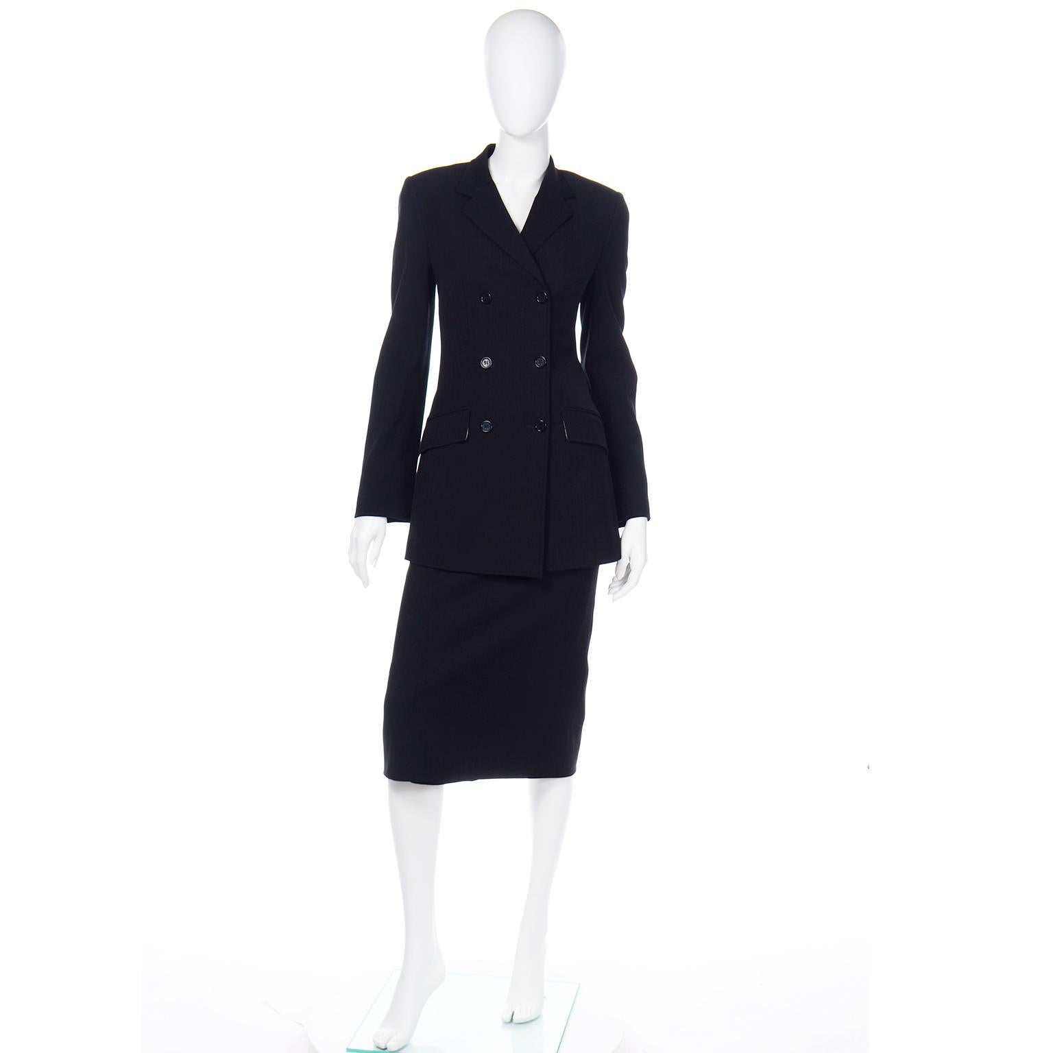 This is a gorgeous Dolce & Gabbana black on black pinstripe skirt and jacket suit with a longline blazer and long midi skirt. We love the way the jacket fits fitted through the bust and waist with a slight flare at the hem. The jacket has shoulder