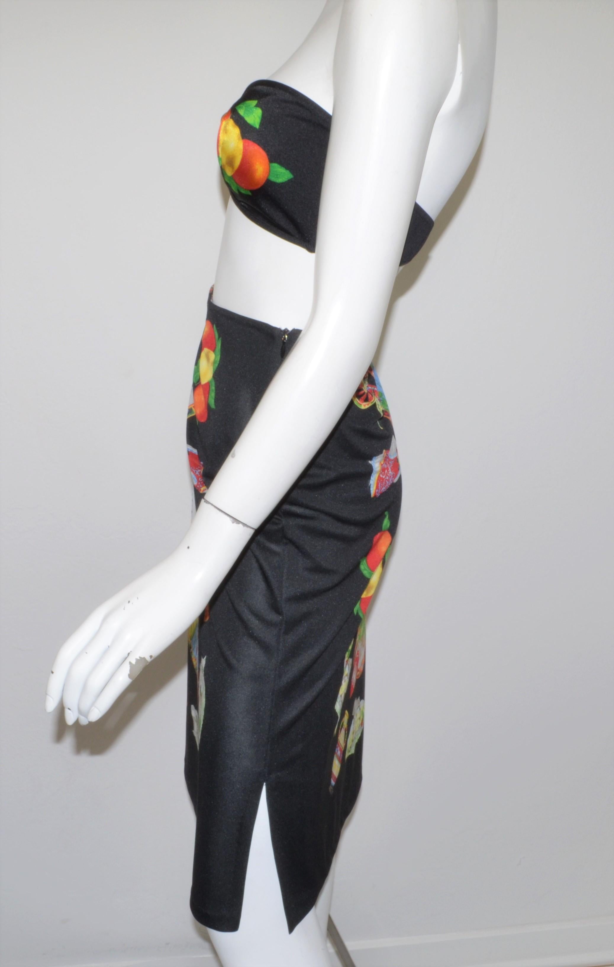 Vintage Dolce & Gabbana Mare Bandaeu Top and Skirt Cover Up with a multicolor print throughout a black background. Skirt is labeled size 46/XL, 100% polyester, made in Italy.

Measurements:
Top - bust 30”
Skirt - waist 30”, hips 38”, length 26”