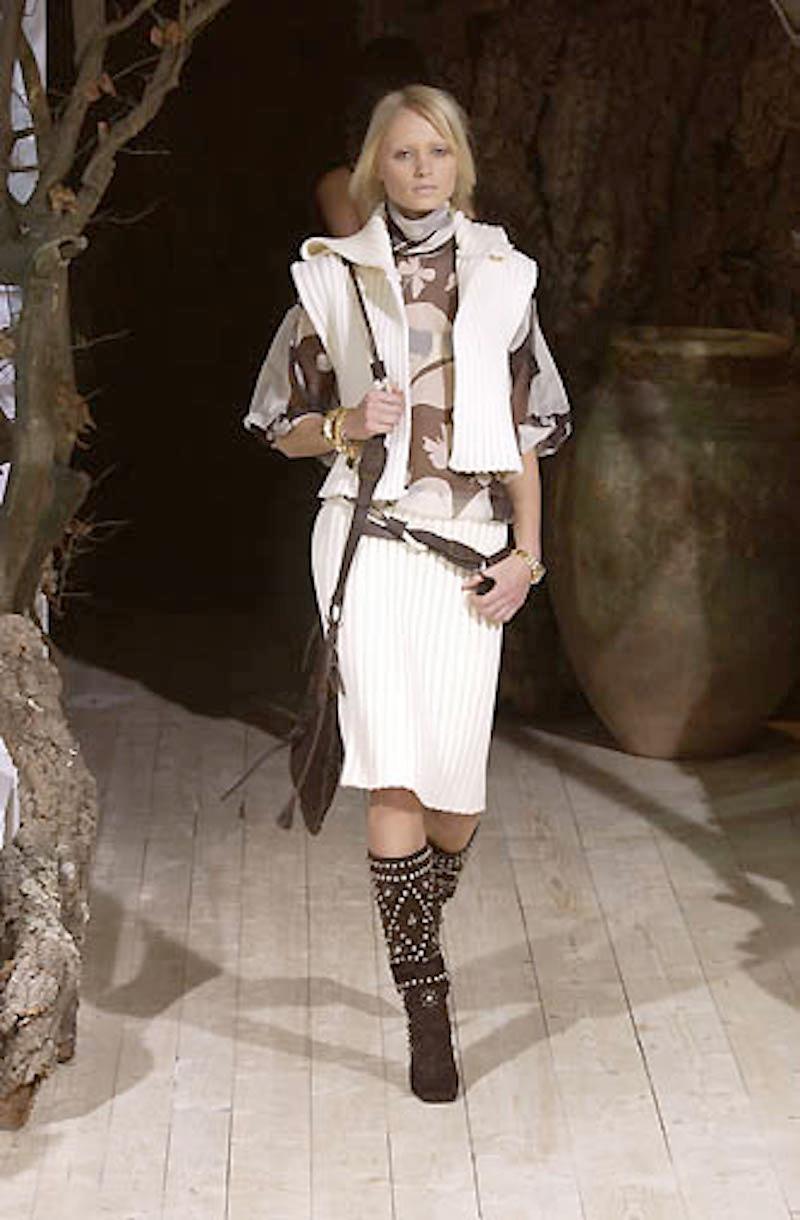 Ce gilet en maille vintage Dolce & Gabbana est un incontournable de la garde-robe féminine. Cette pièce de grande qualité, en 100 % laine, a été présentée sur les podiums en 2002 (saison F/W) et dégage encore aujourd'hui un air de modernité grâce à