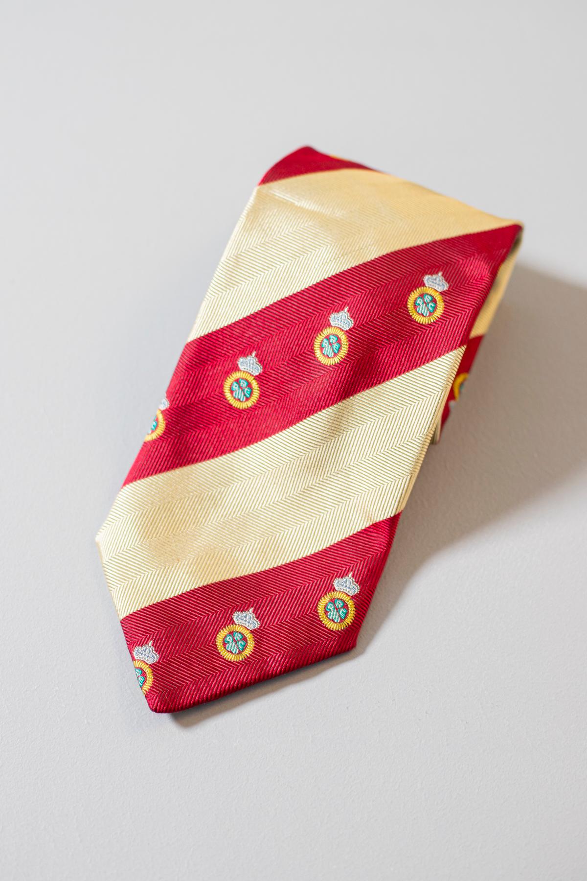 Domenico Basile designed this tie for his Modus Collection. This vintage all silk tie is decorated with red and yellow stripes, and with small medals. This tie is regal and elegant, which make it perfect for a formal event.
