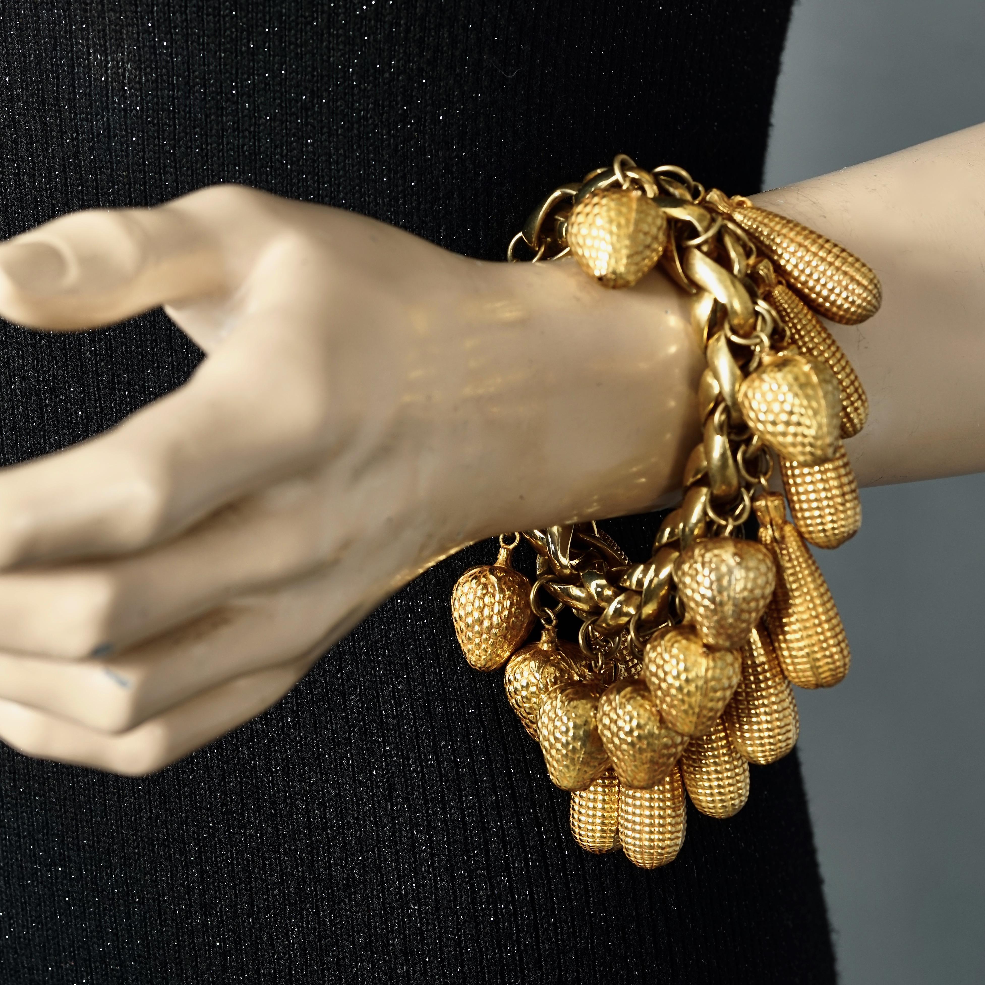 Vintage DOMINIQUE AURIENTIS Vine Leaves Wide Cuff Bracelet

Measurements:
Height: 2.12 inches (5.4 cm)
Wearable Length: 7.87 inches (20 cm) 

Features:
- 100% Authentic DOMINIQUE AURIENTIS.
- Chain bracelet with acorn and corn charms.
- Gold tone