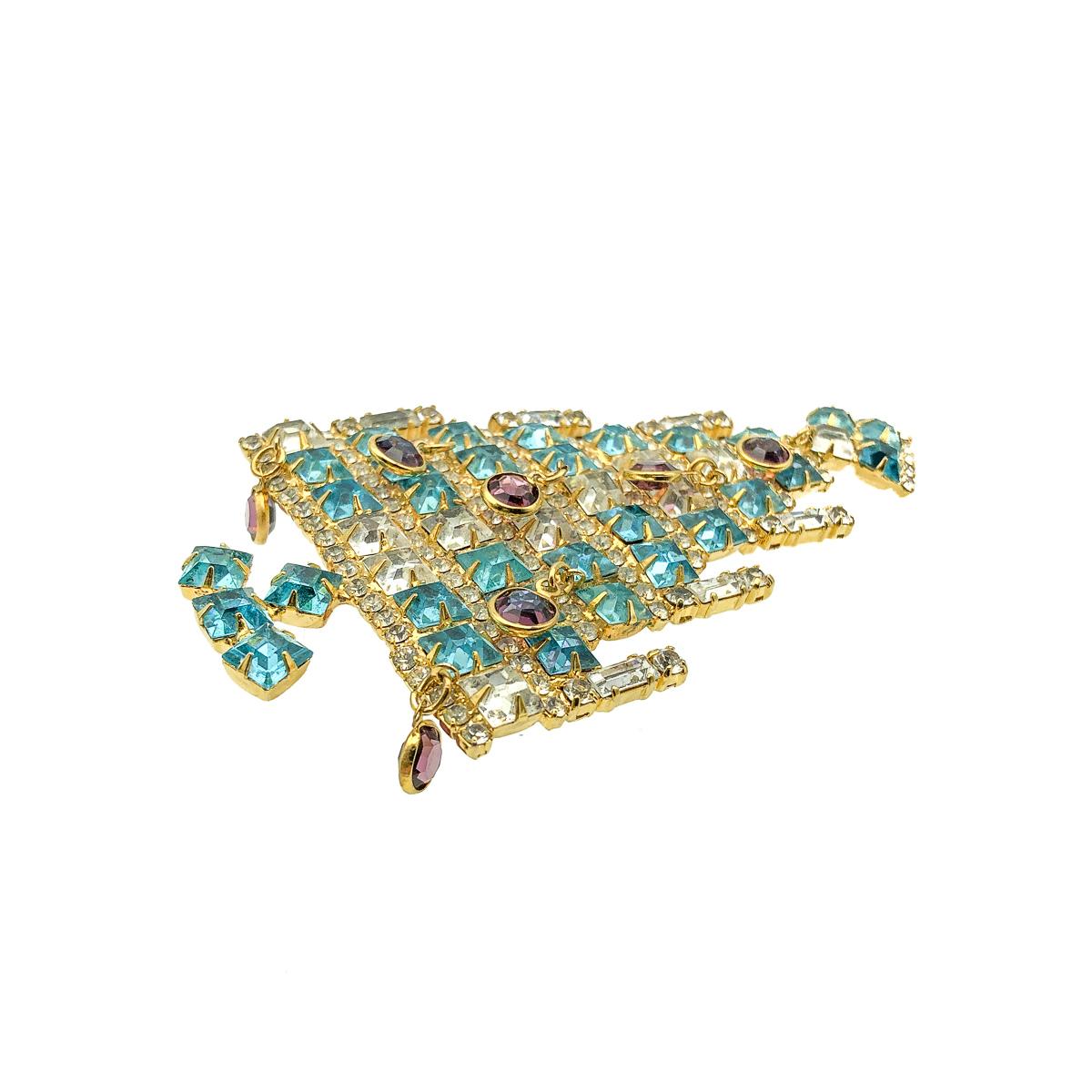 A spectacular and large Vintage Dominique Christmas Tree Brooch with dangling baubles and candles. Crafted in gold plated metal and featuring gorgeous square cut crystal stones in turquoise and white with six crystal baguette stone candles and