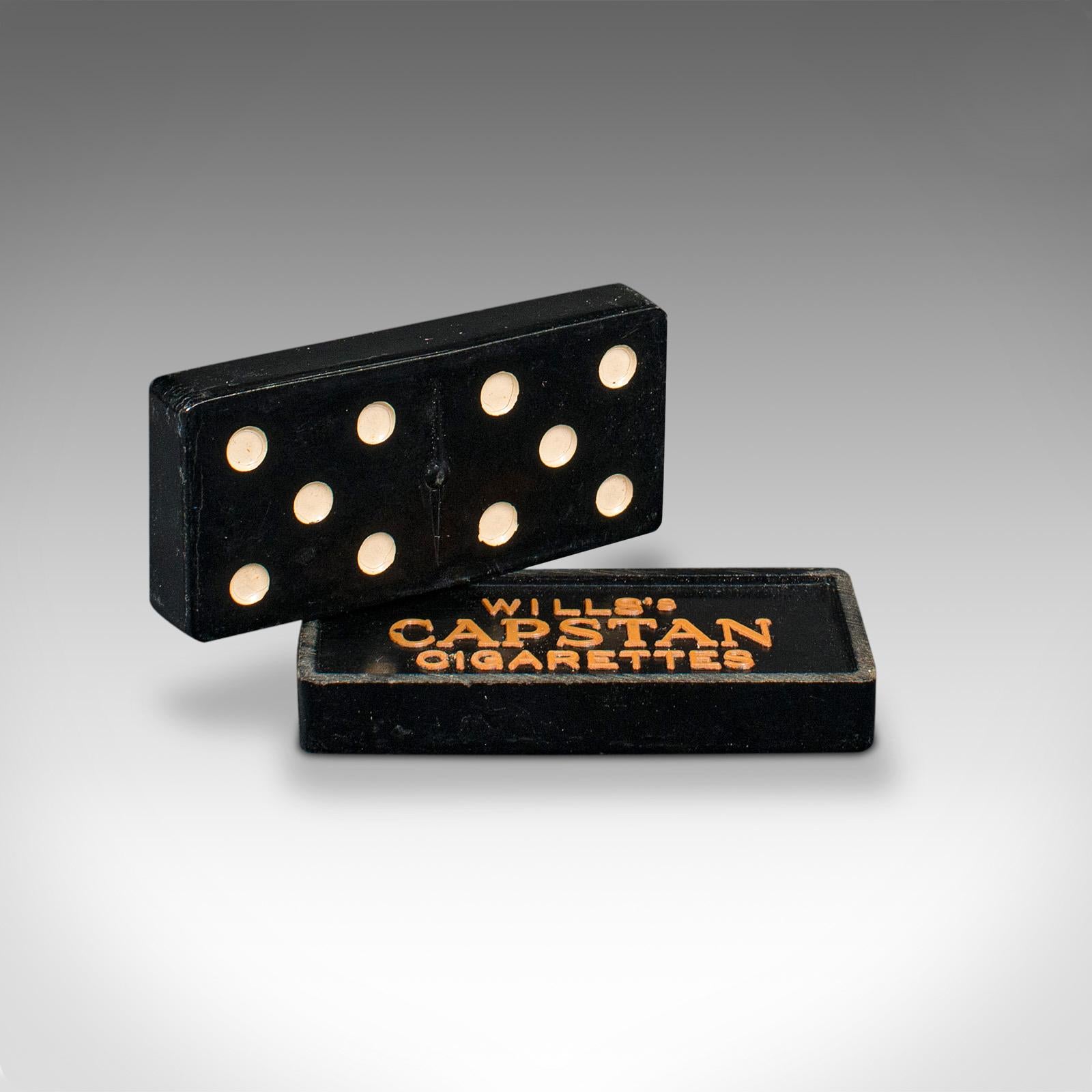 This is a vintage dominoes set. An English, bakelite game in a tin carry case, dating to the mid 20th century, circa 1940.

An enduring favourite, with wonderful period appeal
Displays a desirable aged patina throughout
28 bakelite pieces with