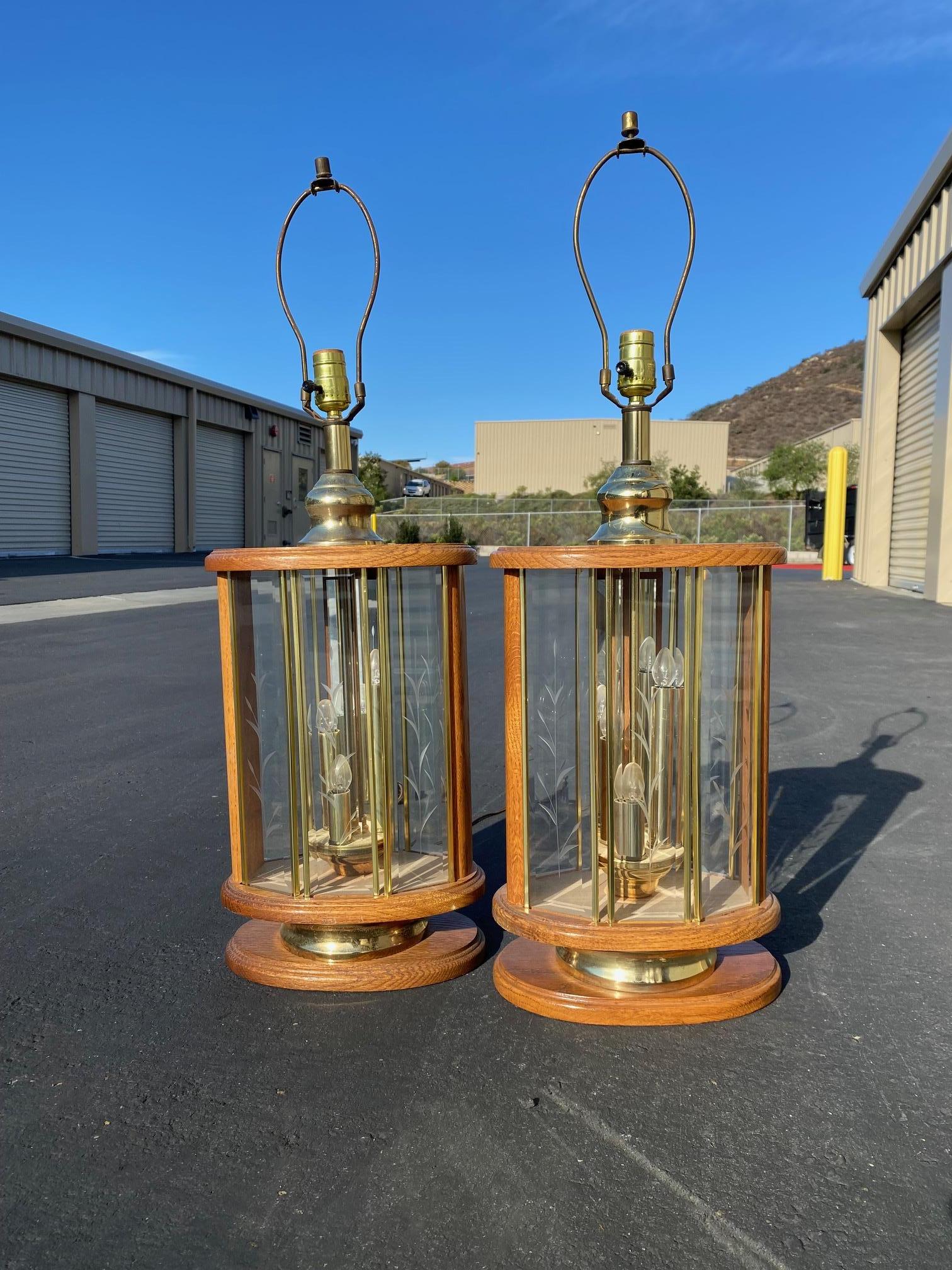 Beautiful pair of vintage wood and brass lamps. The glass panels on these light fixtures have an etched leaf design.