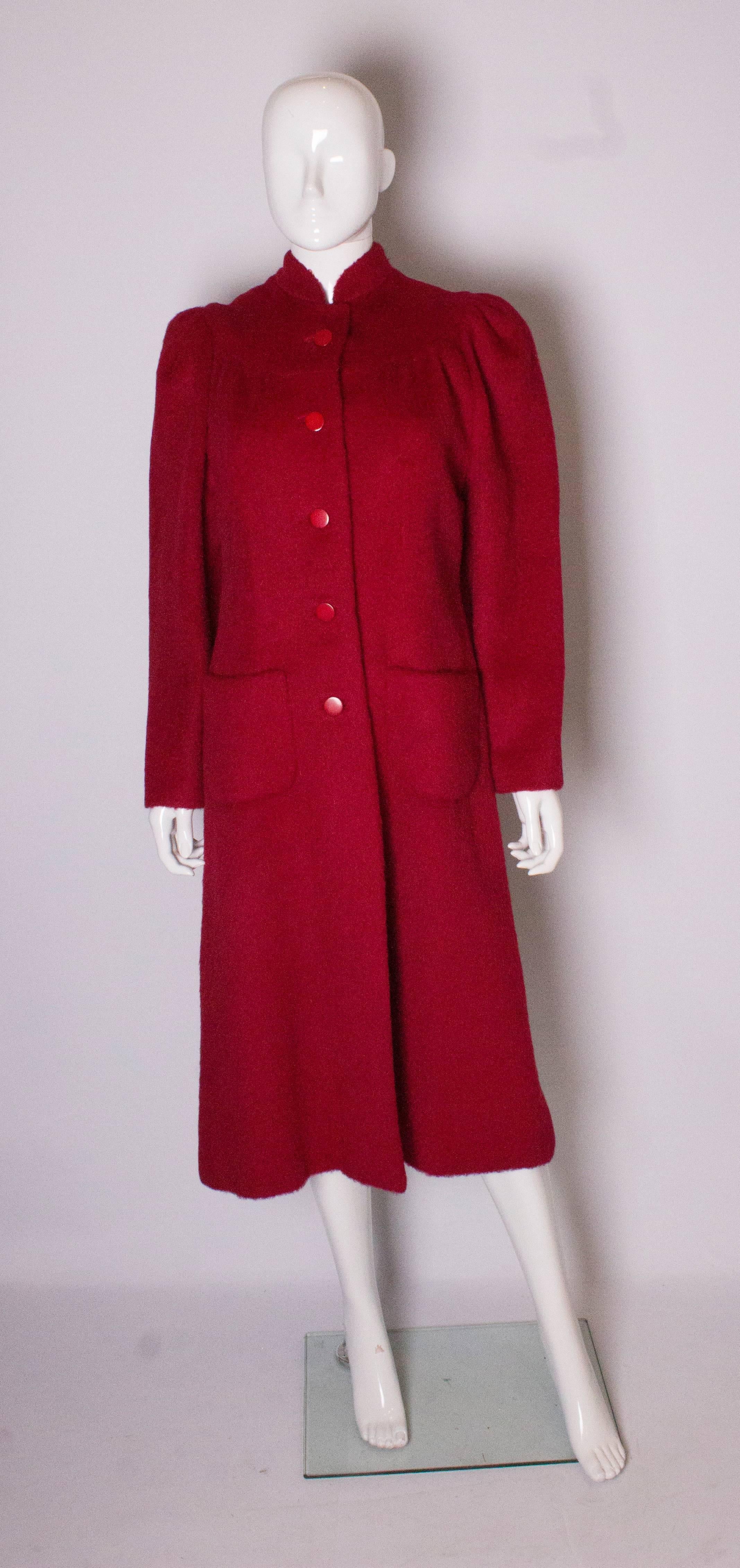 A warm and elegant  vintage  coat by Donald Campbell. The coat has a stand up collar, yoke, 5 button opening  at the front and two pockets. It is fully lined.