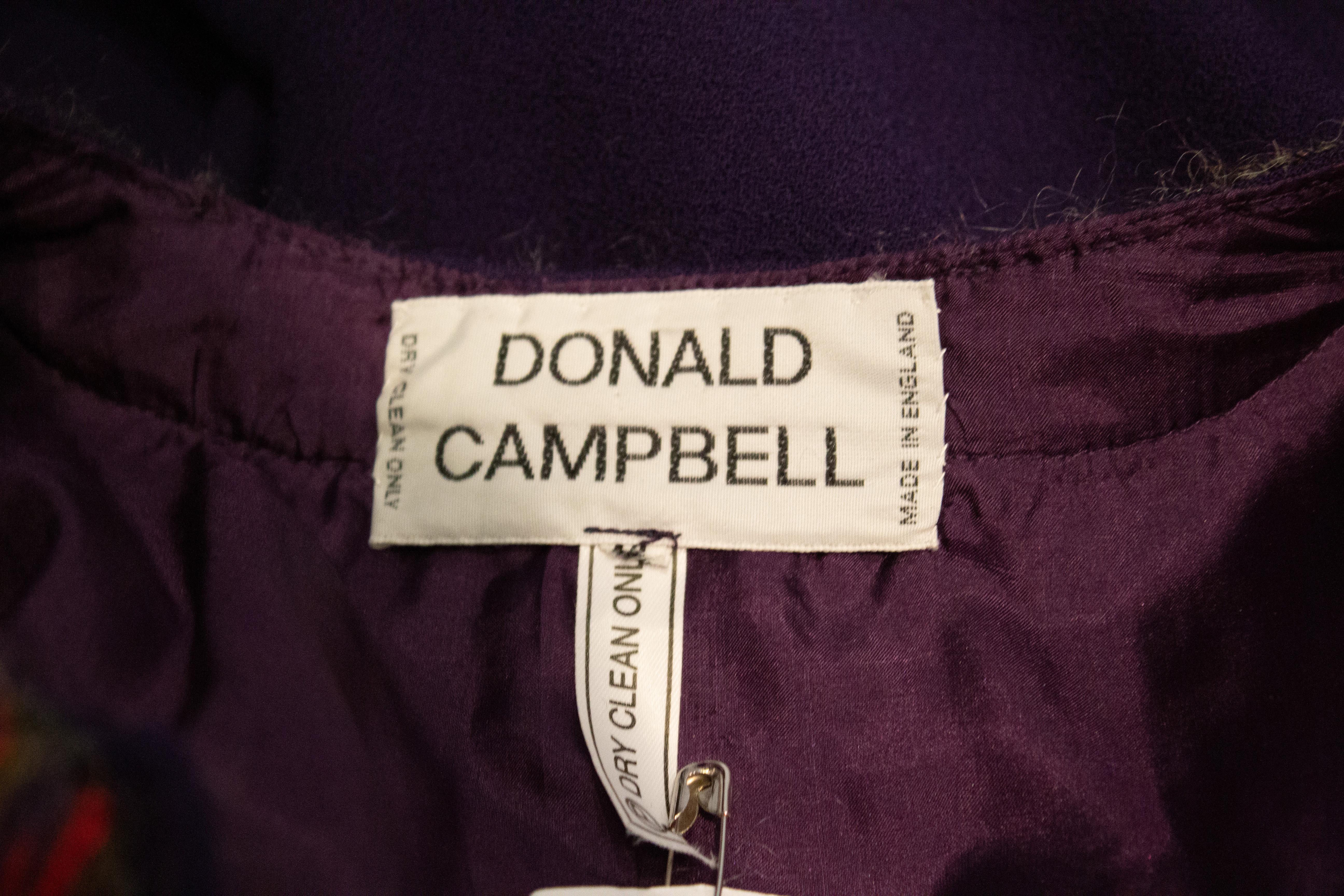 A chic dress for Fall by Donald Campbell. The dress is in a purple wool crepe ( crepe de Paris) with a pink, grey and purple trim. The upper area is fully lined.
Measurements: Bust up to 42'' Length 50''

