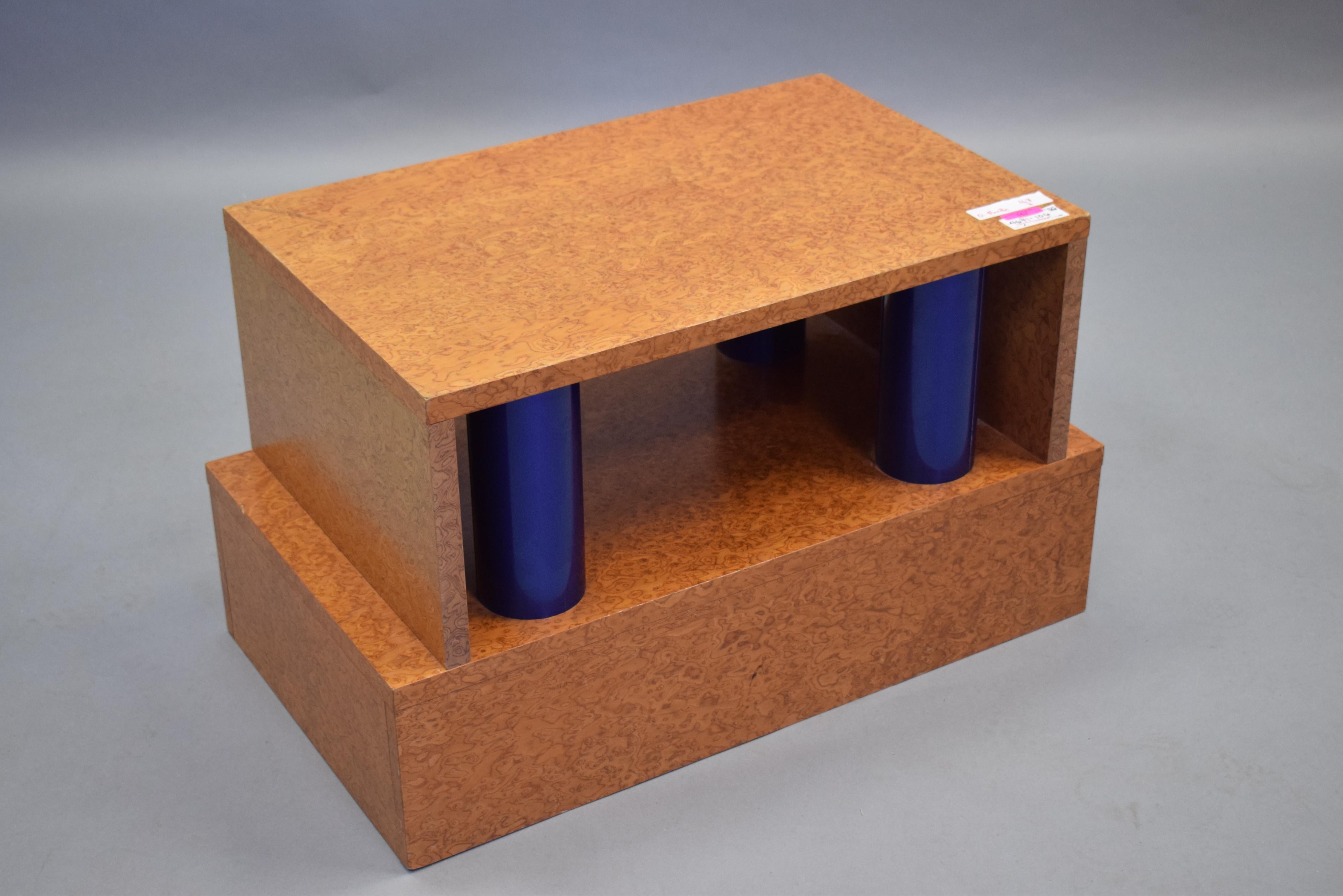 Incredibly rare and exceptional post-modern coffee table by the two of the masters of design, Ettore Sottsass and Marco Zanini. Table is executed in birds eye maple has blue tubular steel rods support the tabletop and creates a visually interesting