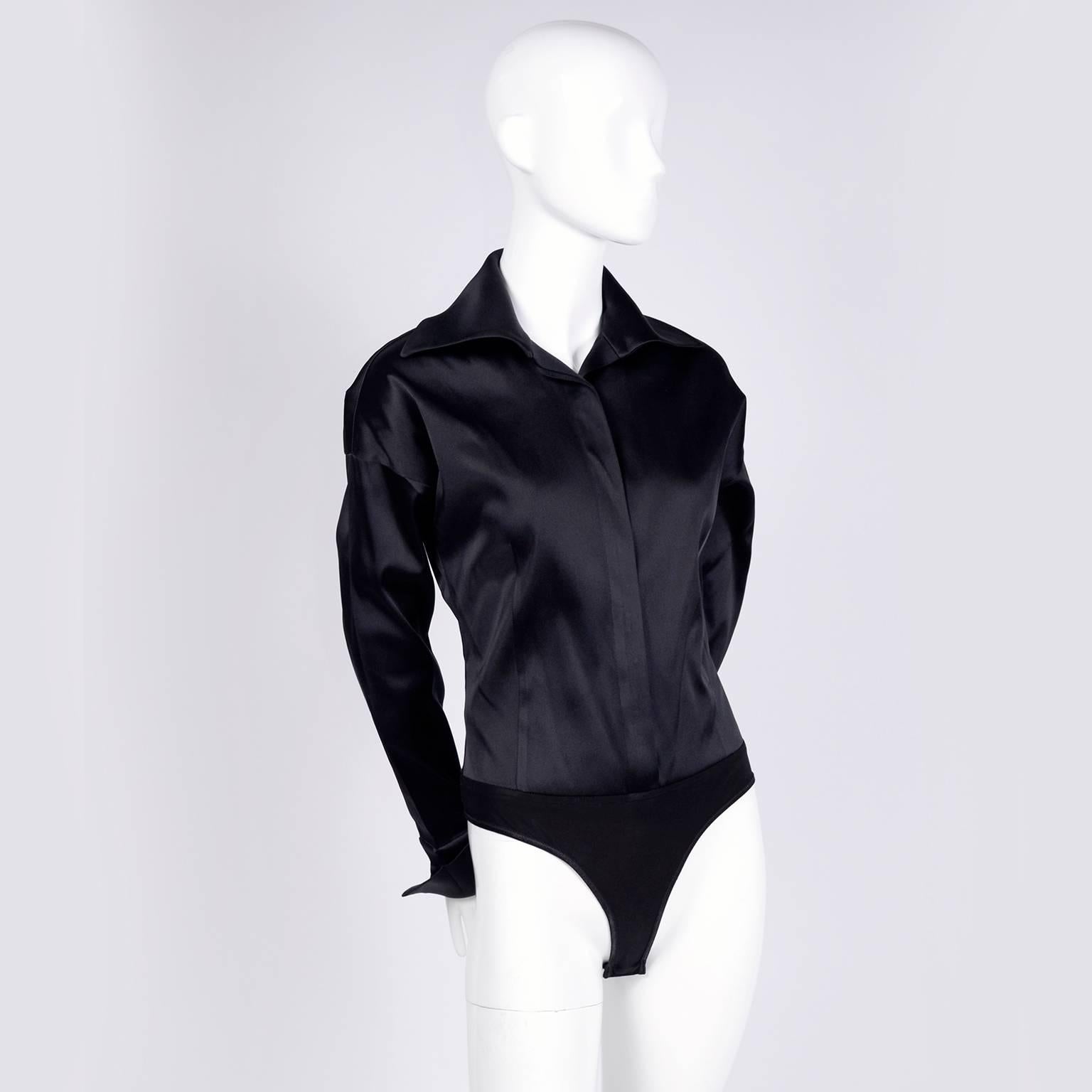 This is an amazing Donna Karan Bodysuit with French cuffs and a wide spread collar. The blouse buttons up the front and snaps at the bottom. This Donna Karan black label top was made in Italy and is in 50% silk, 38% acetate, 8% Rayon, and 4%