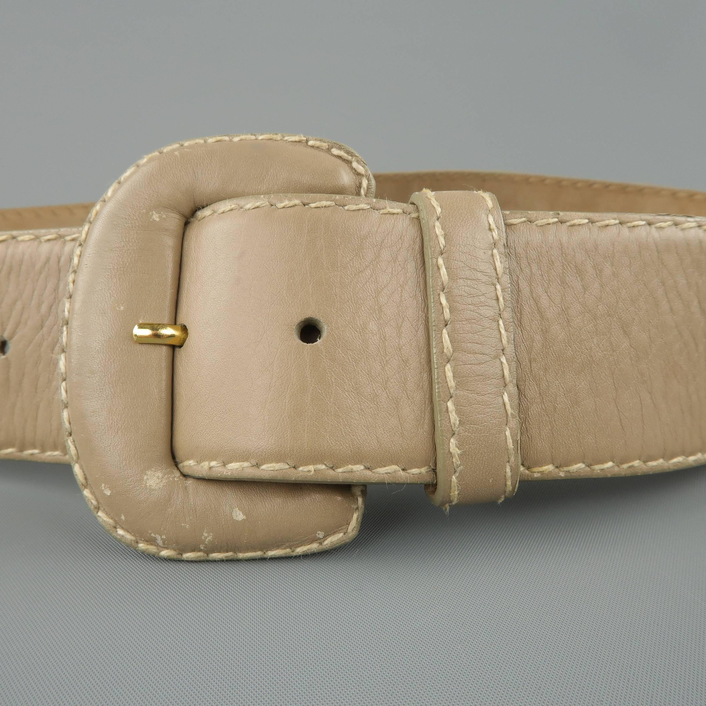 Vintage DONNA KARAN waist belt comes in light taupe gray leather with contrast stitching and a covered buckle. Wear throughout. As-is. Made in Italy.
 
Fair Pre-Owned Condition.
Marked: Medium
 
Length: 38 in.
Width: 2 in.
Fits: 27-32 in.

