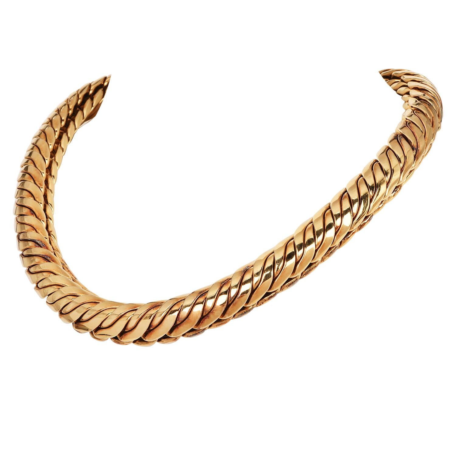 Bold, sculptural, and luxurious, this vintage 1980S solid 18K gold choker by Dorfman is a true statement in timeless design. Featuring a sleek wavy link motif, it lies flat against the neck with a subtle 10mm domed profile, delivering a bold