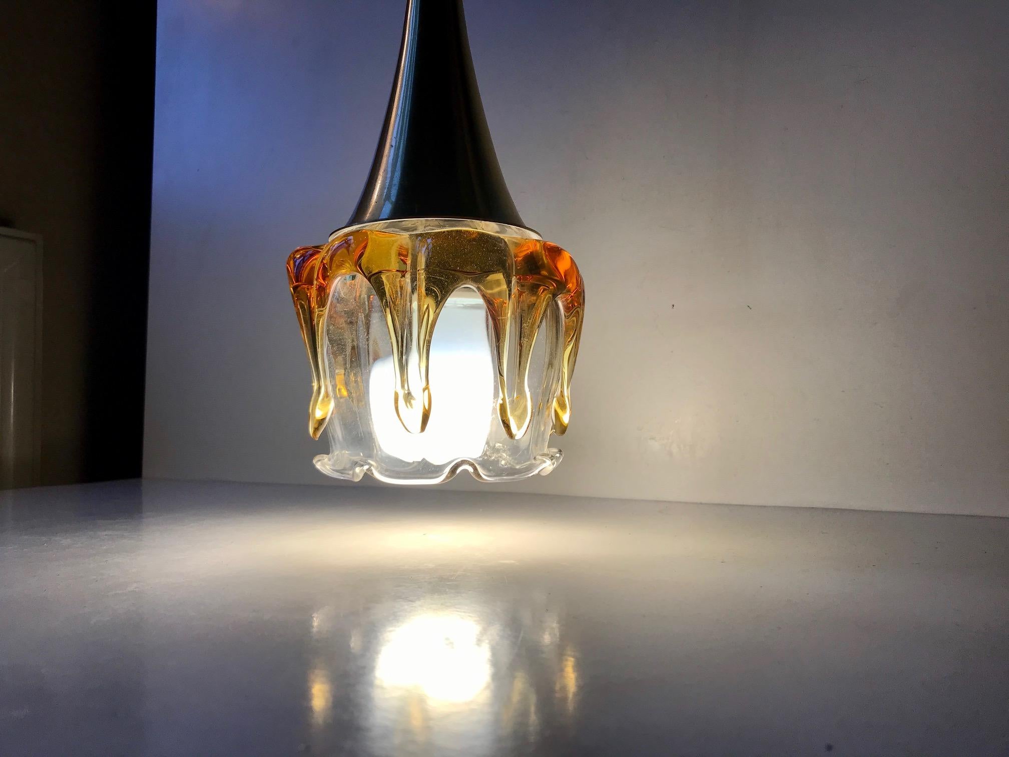 A small ice-cone shaped pendant light executed in brass-alloy aluminium and hand blown Murano glass. It was manufactured by Doria in Germany during the 1970s.
