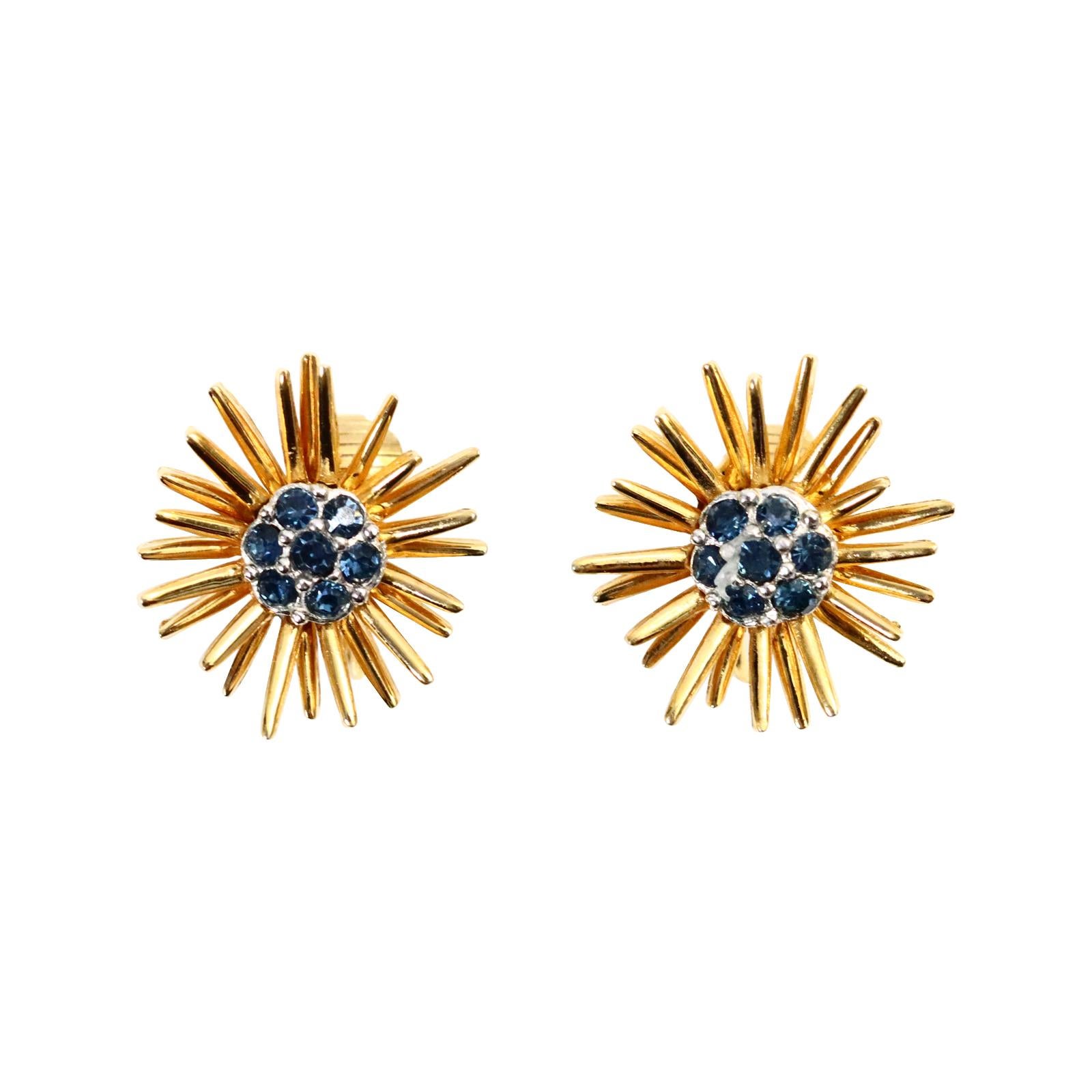 Vintage D'orlan Gold Starburst with Blue Diamante Earrings Circa 1980s. These earrings look so chic due to its juxtaposition with the gold and then the blue set in silver tone metal in the middle. They are well made and give the air of fine jewelry.