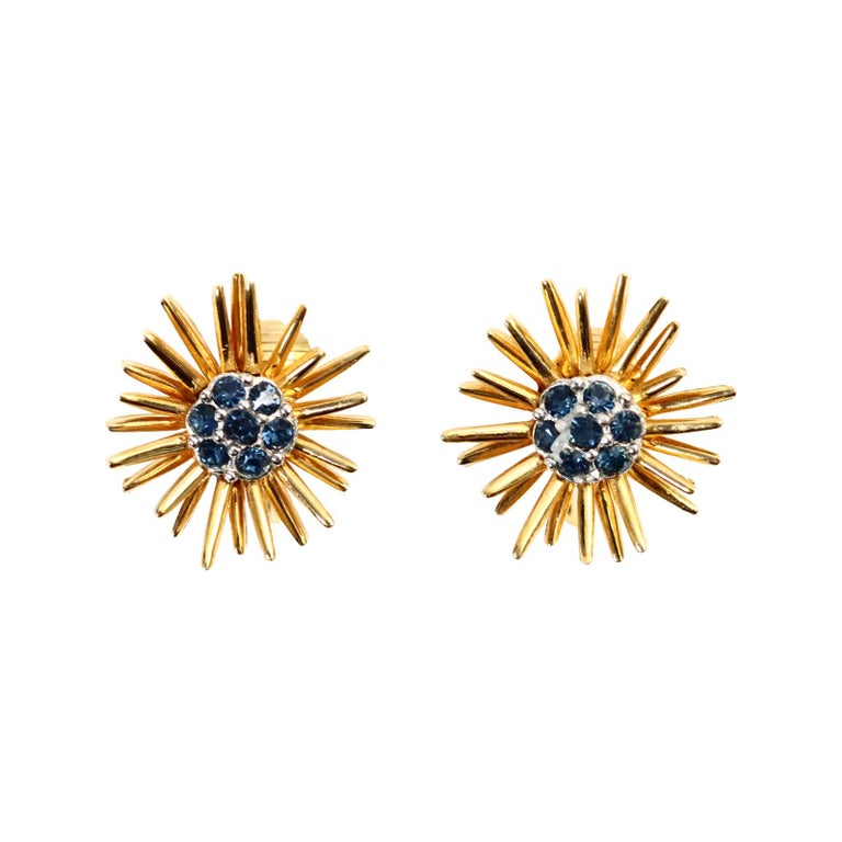 Vintage D'orlan Gold Starburst with Blue Diamante Earrings Circa 1980s. These earrings looks so chic due to its juxtaposition with the gold and then the blue set in silver tone metal in the middle.They are well made and gives the air of fine