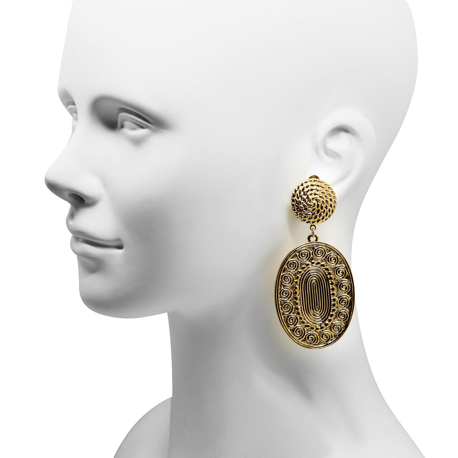 Vintage D'Orlan Gold Tone Byzantine Dangling Earrings. Large oval highly detailed dangling pieces hang down from a rope like top piece. Clip on. You can wear the plainest and cheapest outfit and put these on and you will be puled together.  

 If