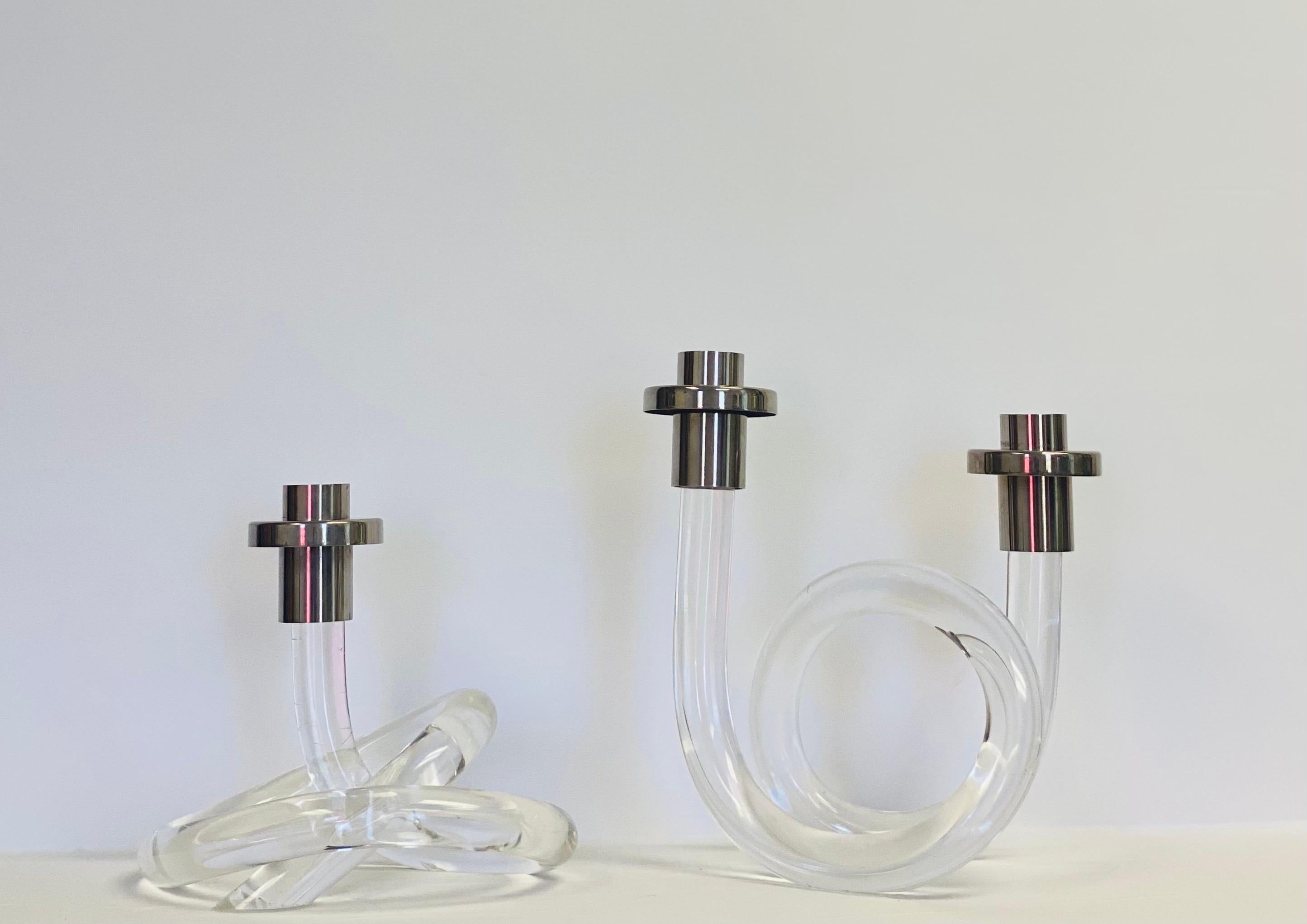 We are very pleased to offer a modern pair of candlesticks by Dorothy Thorpe, circa the 1970s. These eye-catching sculptural candlesticks are crafted from beautiful Lucite and twisted for a structural display piece that is sure to make a statement.