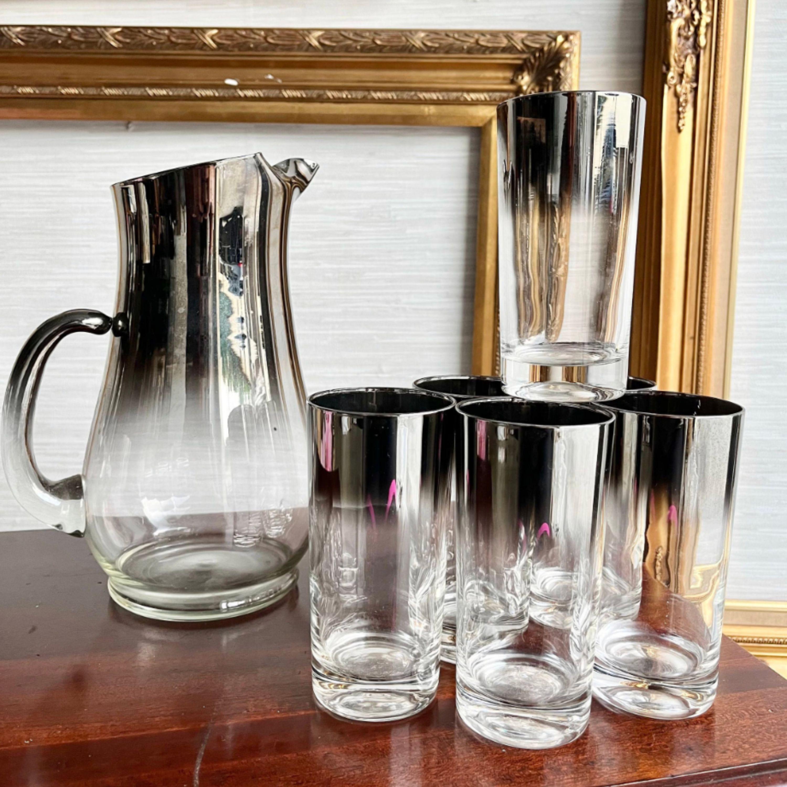Elevate your cocktail hour with this iconic 1960s Dorothy Thorpe-style glassware set. Featuring the timeless Silver Fade Design, this 7-piece ensemble includes a sleek cocktail pitcher and six matching highball glasses, perfect for serving drinks