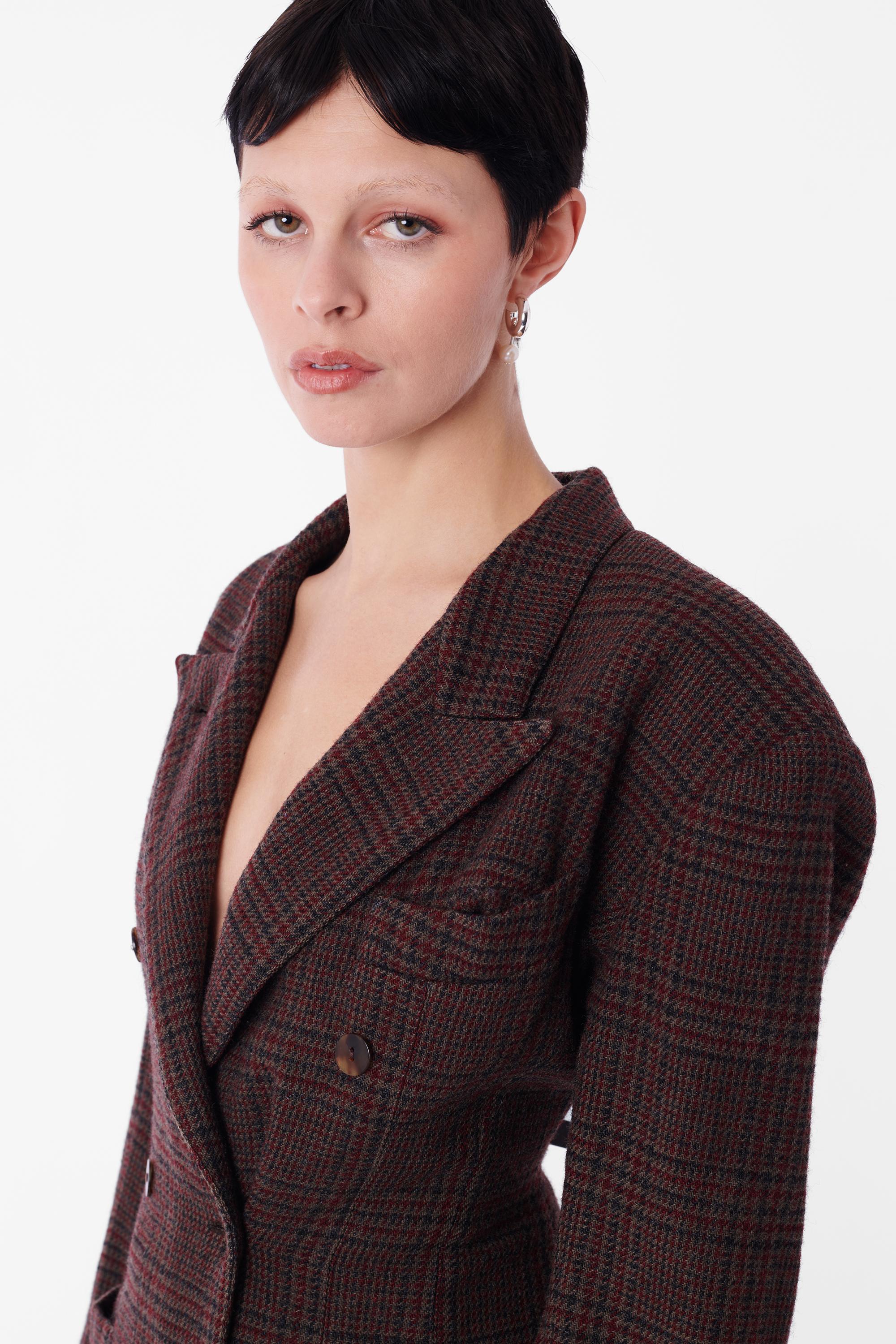 Vintage Jean Paul Gaultier wool blazer. Features double breasted silhouette, front left chest pocket and two hip pockets in a wool tartan with full interior lining. In great vintage condition. Authenticity Guaranteed.

Size: UK 8
Color: Brown
Modern