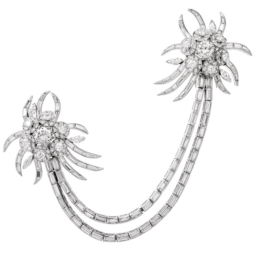 This opulent Vintage pin consisting of two floral motif lapel brooches and dual baguette diamond links are crafted in solid Platinum, weighing 52 grams in total. The two of diamond lapel brooches simulating flowers, leaves and stems, are each