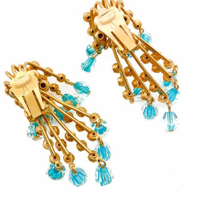 How beautiful. These Vintage Double Cascade Earrings are so clever in their design. Featuring a double row of claw set rhinestones and turquoise lined crystal drops that shimmer adorably when they tremble. Created in gold plated metal. In very good