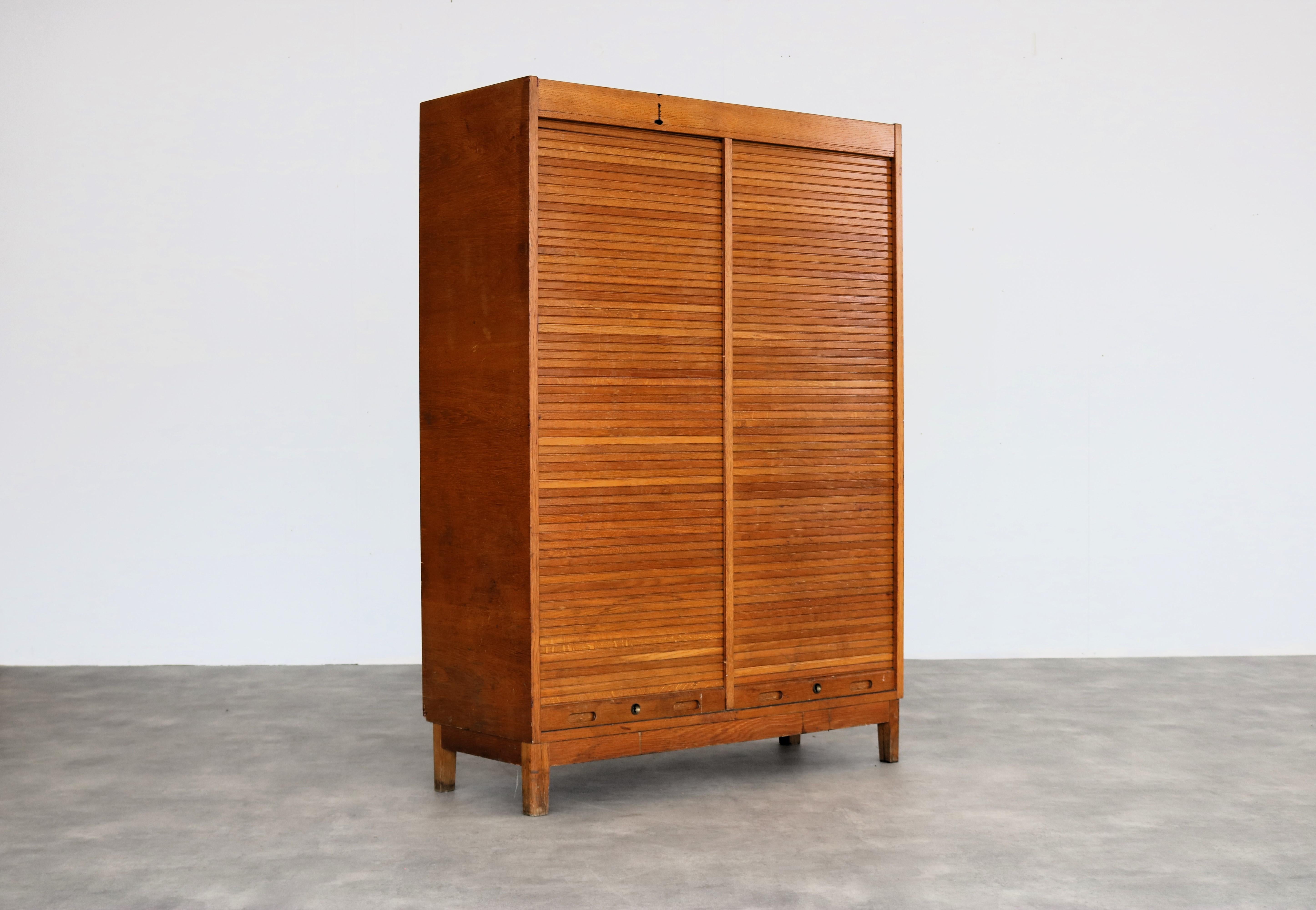 vintage double filing cabinet  cupboard  1950s  Swedish

period  1950s
design  unknown  Sweden
condition  good with signs of use  keys are missing;
size  145 x 103 x 40 (hxwxd)

details  teak; tambour roller doors;

article number  2392