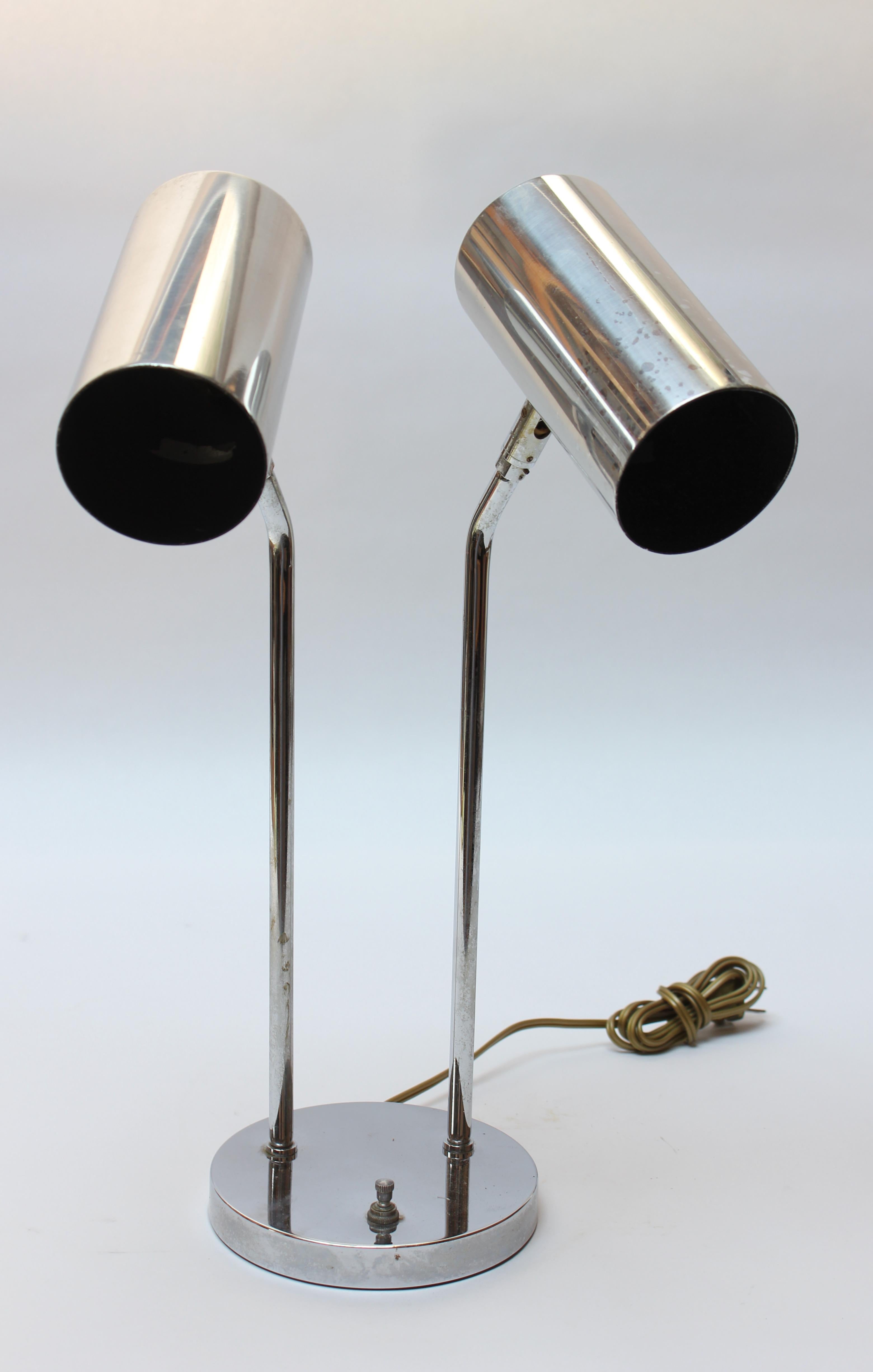 Chrome table lamp by Robert Sonneman for Koch & Lowy (ca. 1970s). Composed of two pivoting, cylindrical shades supported by tubular-chrome stems and a round base with a single on / off switch that allows for one or both of the lights to be on at a