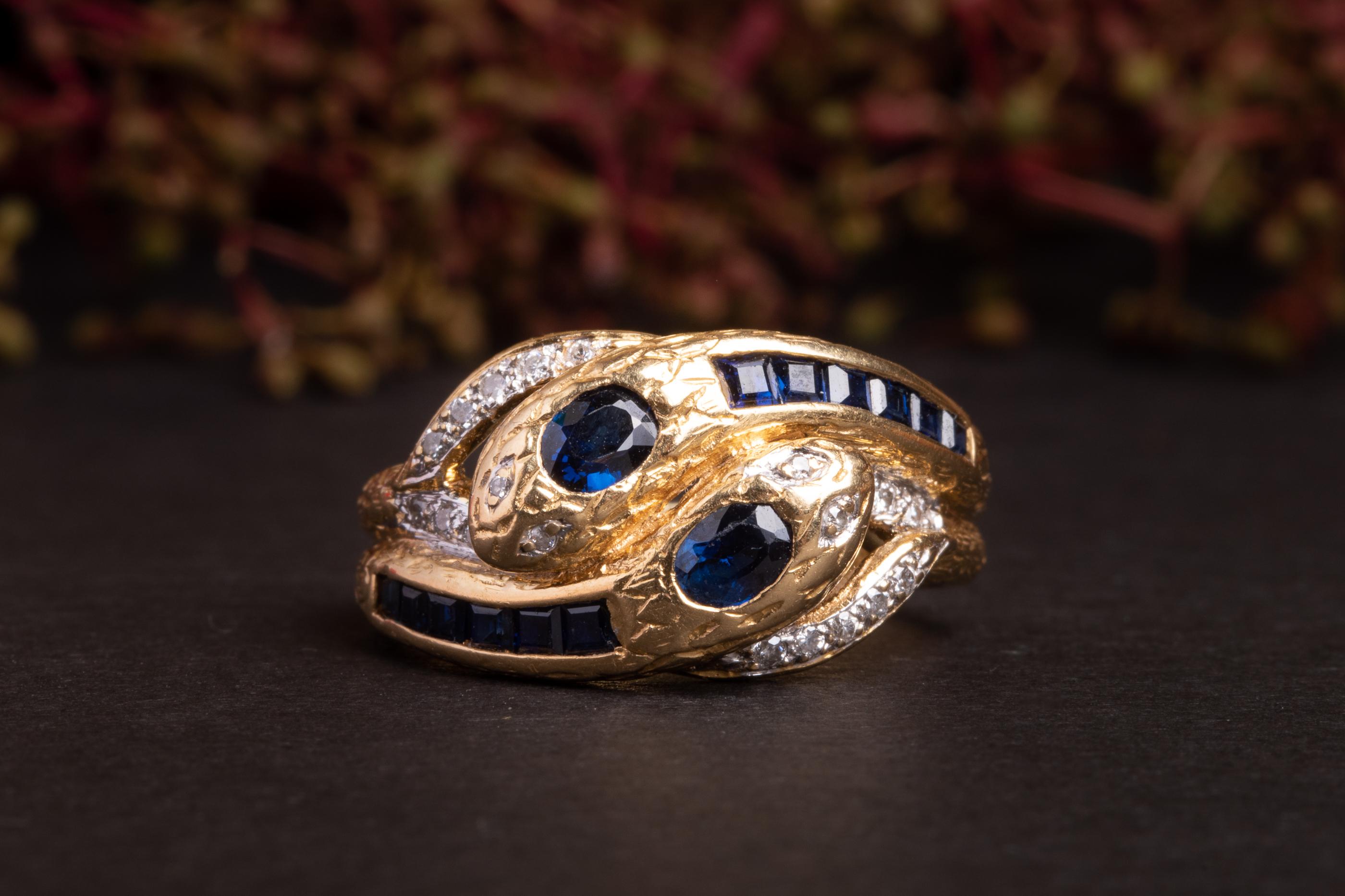 A rather unique gold vintage snake ring. Made of solid 18k yellow gold and set with blue sapphires and diamonds this snake is rather substantial and weights almost 5 g!

The body of the snake is very detailed with gold coils and diamonds accenting