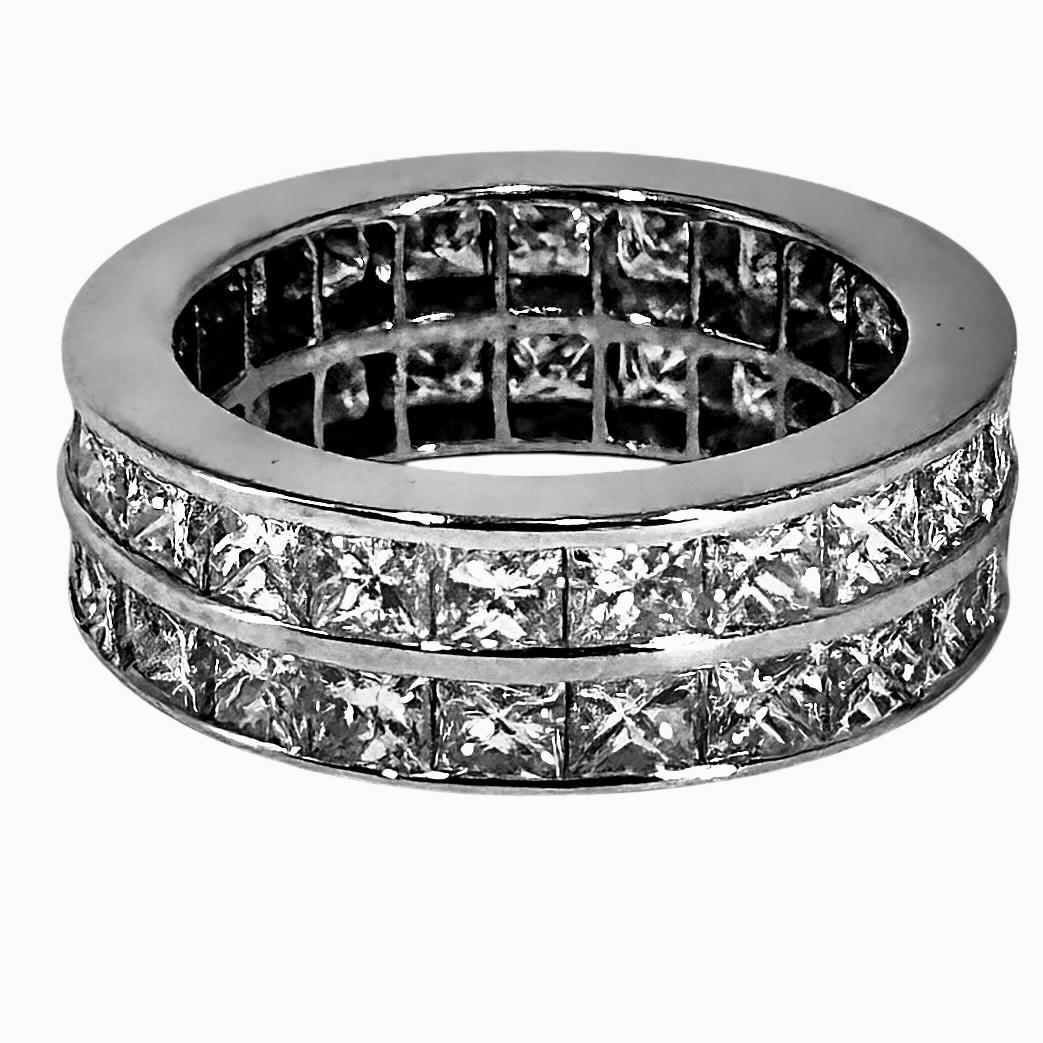 This scintillating and deftly crafted vintage platinum Princess cut double row diamond wedding band is channel set with approximately 44 fine quality stones, having an approximate total weight of 5.50ct. Overall diamond quality is G/H color and VS1.
