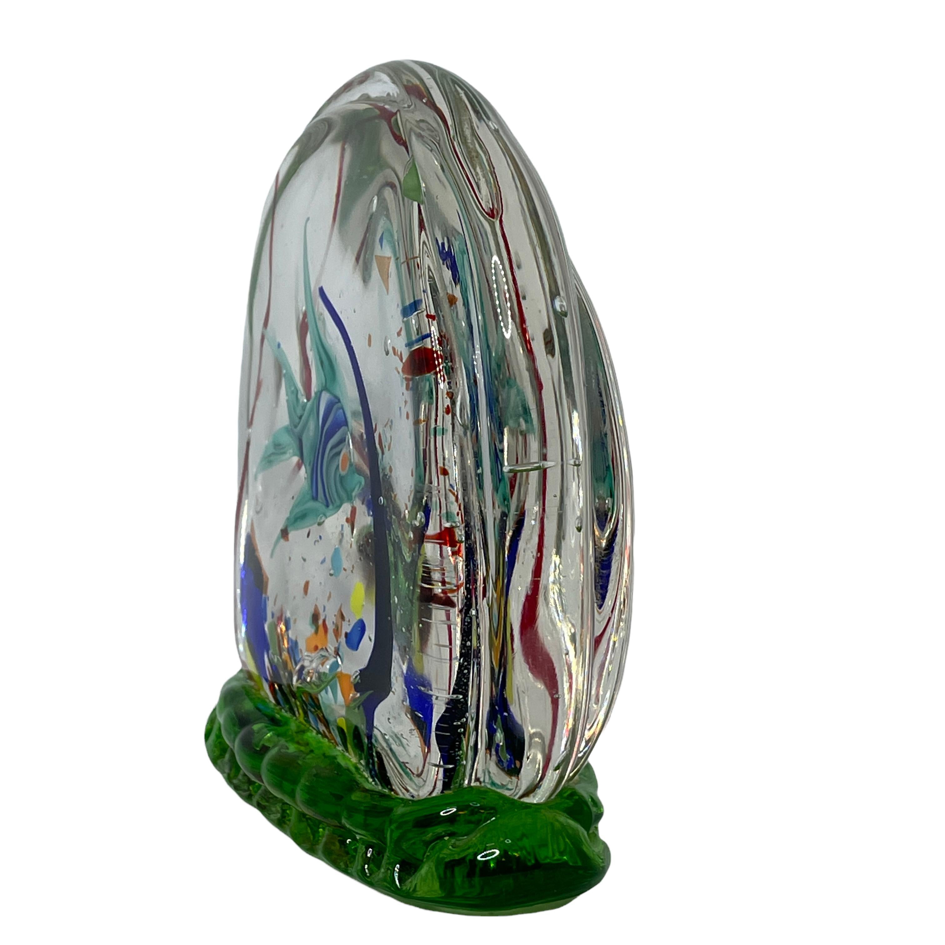 Beautiful Murano hand blown aquarium Italian art glass paper weight or sculpture. Showing a fish. Colors are a different shades of blue, red, yellow and clear. A beautiful nice addition to your desktop or as a decorative piece in every room.