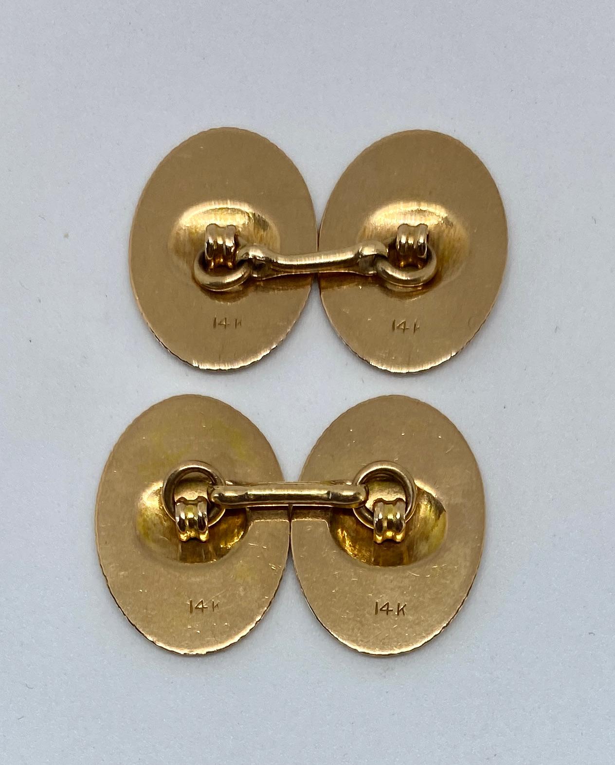 A wonderful pair of oval cufflinks in 14K rose gold featuring intricate milgrain details.

The four cufflink faces each measure 20 mm by 14.4 mm. They're stamped 