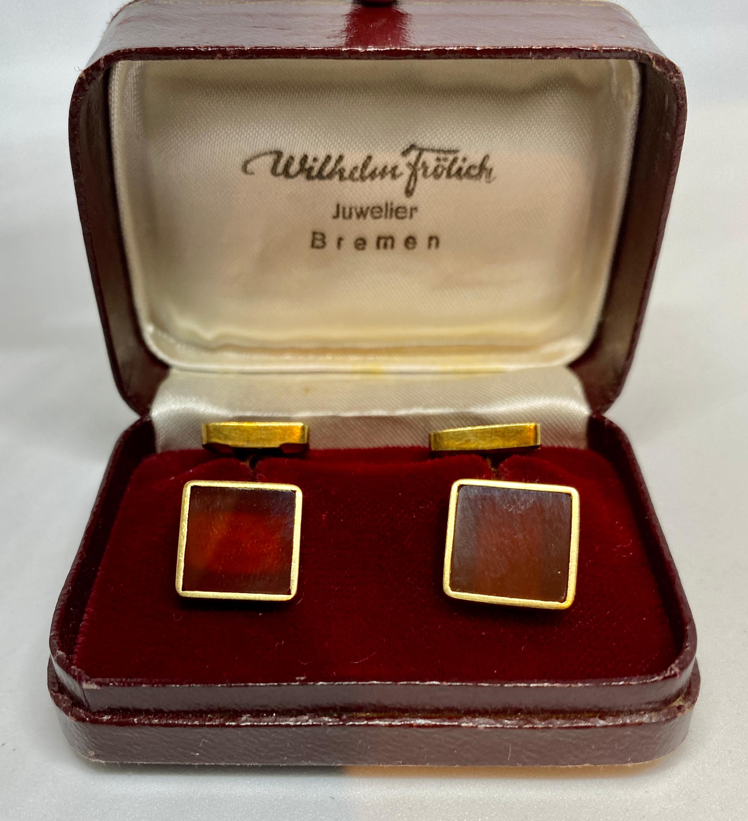 A very fine pair of double-sided cufflinks featuring four square-cut carnelians set in 14K yellow gold with chain connectors. Comes in original box from Wilhelm Frölich of Bremen, Germany.

Each of the four cufflink faces measures 12.8mm square and