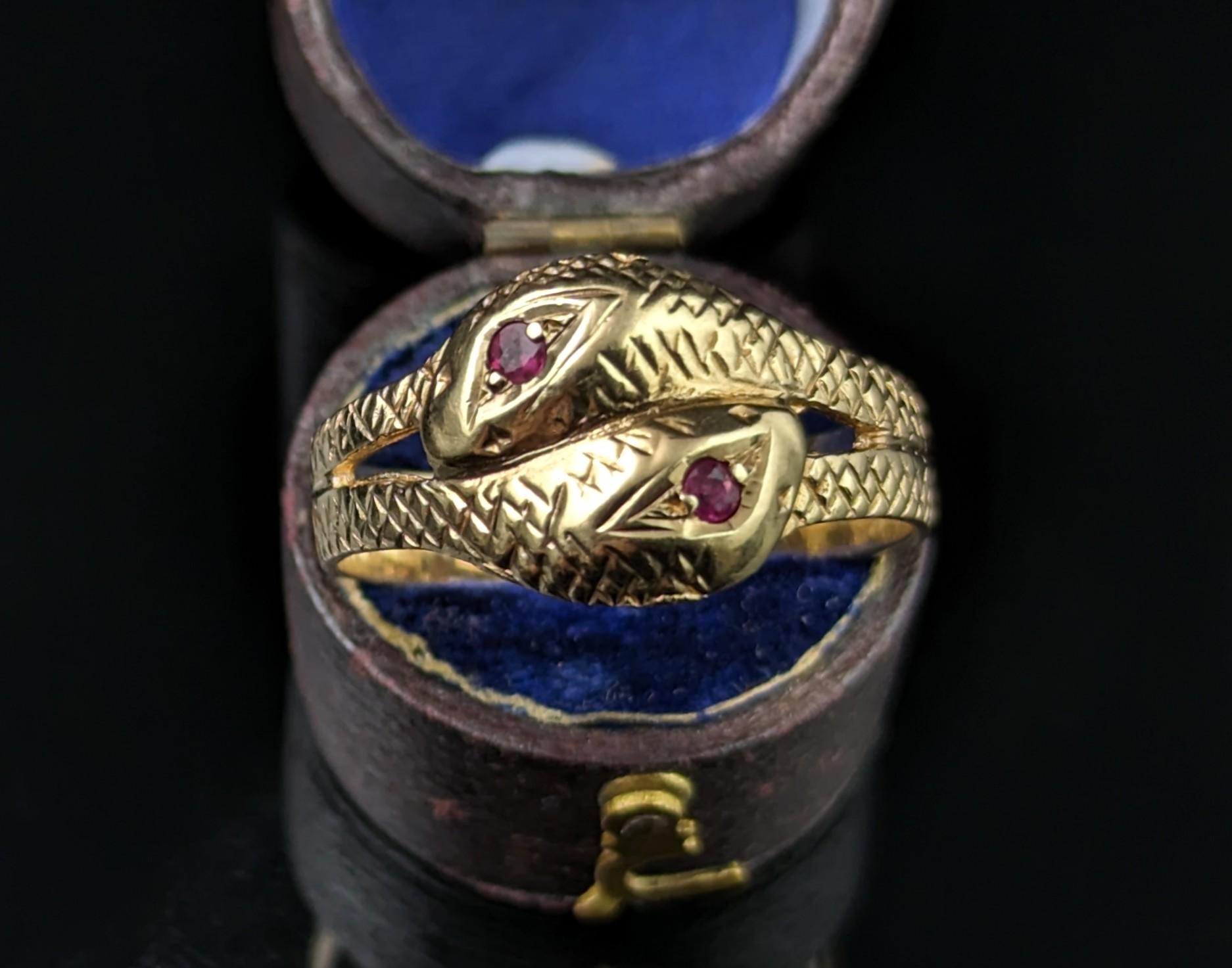 You can't help but be charmed by this awesome vintage double snake ring.

Coils of rich 9ct yellow gold form the body of these handsome intertwined snake friends, the heads are modelled at the face of the ring with the snakes both having ruby set
