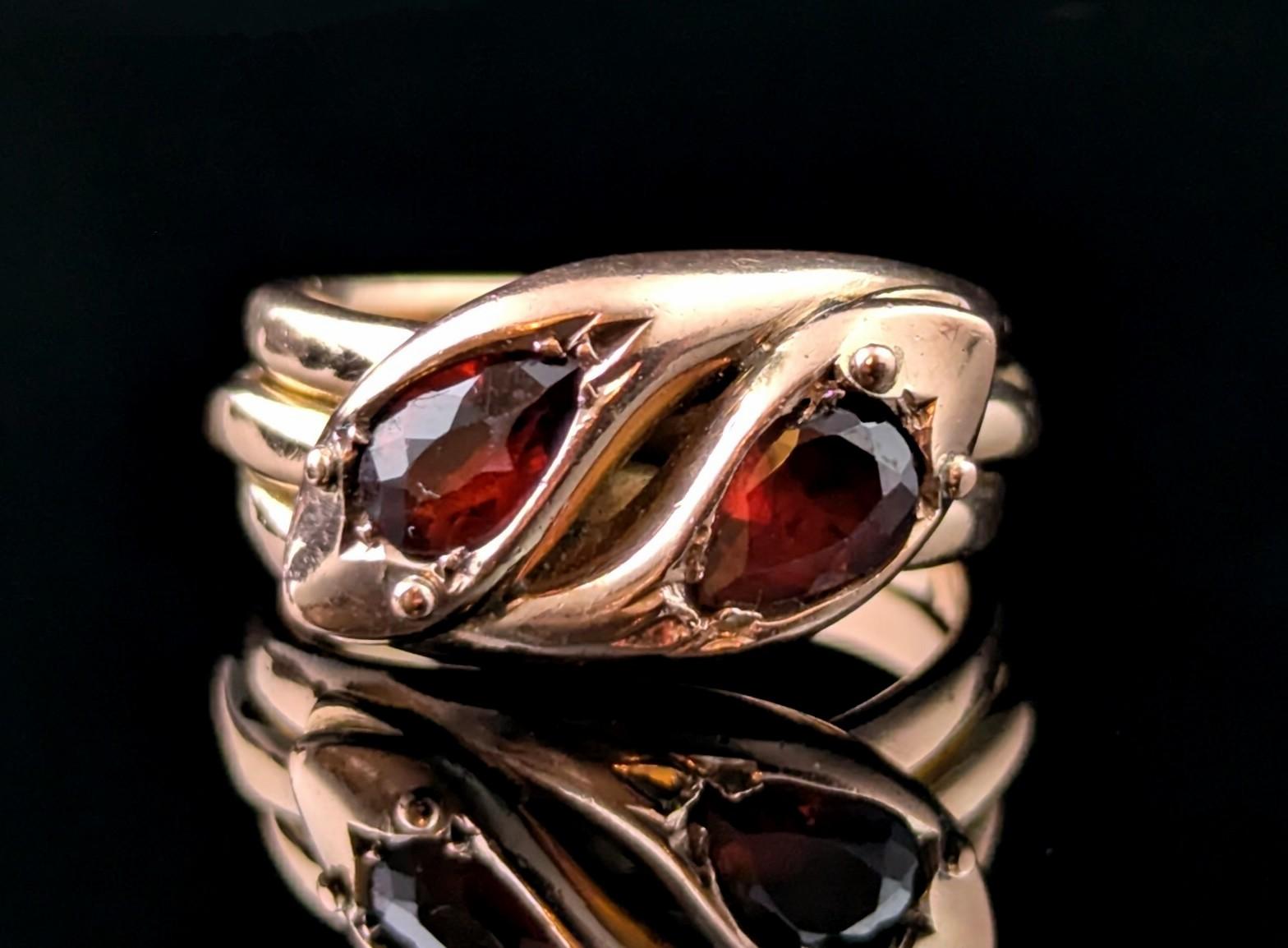 You can't help but be charmed by this gorgeous vintage double snake ring.

Coils of rich 9ct Rose gold form the body of these handsome intertwined snake friends, the heads are modelled at the face of the ring with the snakes both having pear cut