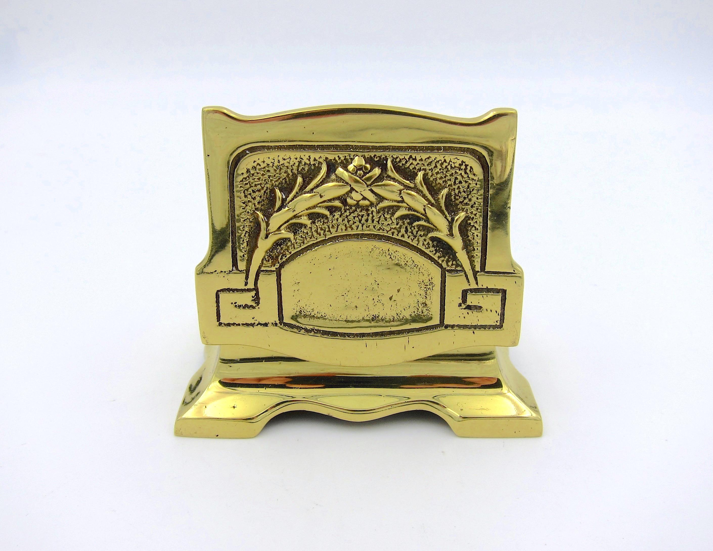 A vintage double stamp box in solid cast brass, designed with a neoclassical garland and Greek key motifs decorating the hinged lid. The small desk accessory has two slanted interior compartments for postage stamps, but the design would make an