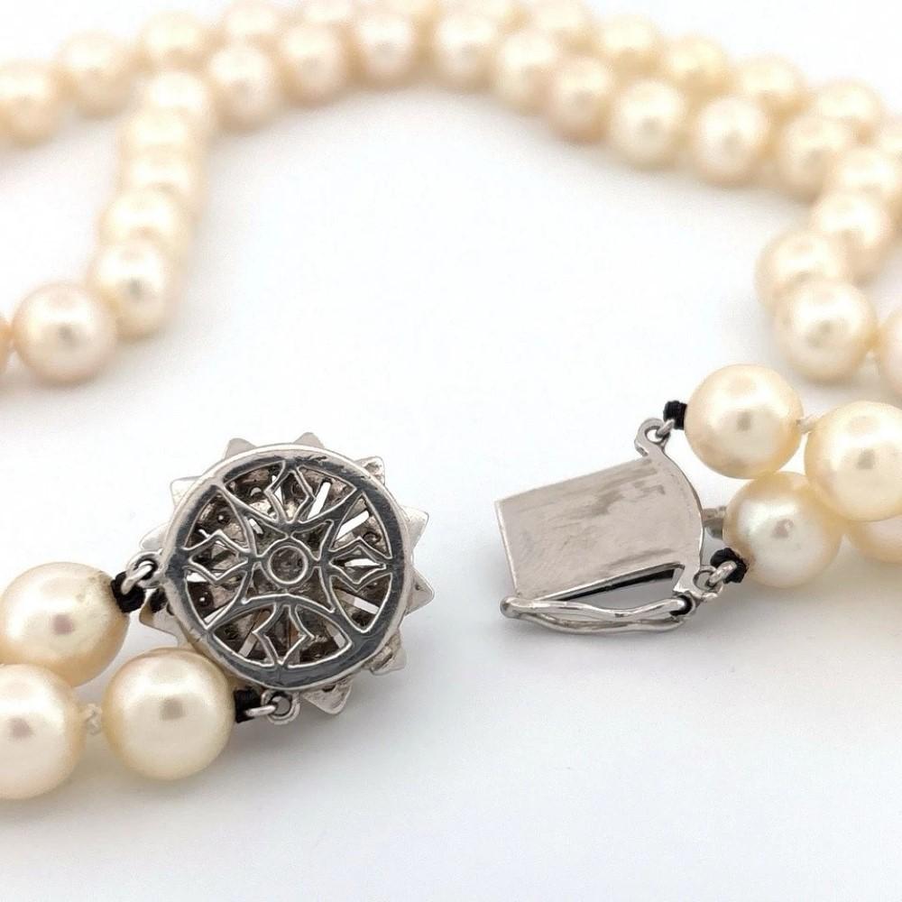 Vintage Double Strand 8.45mm Akoya Pearl Necklace – 14K White Gold & Diamond Clasp

Description:
This elegant double-strand Akoya pearl necklace features lustrous 8.45mm pearls that are non-graduated and individually knotted on silk. The pearls