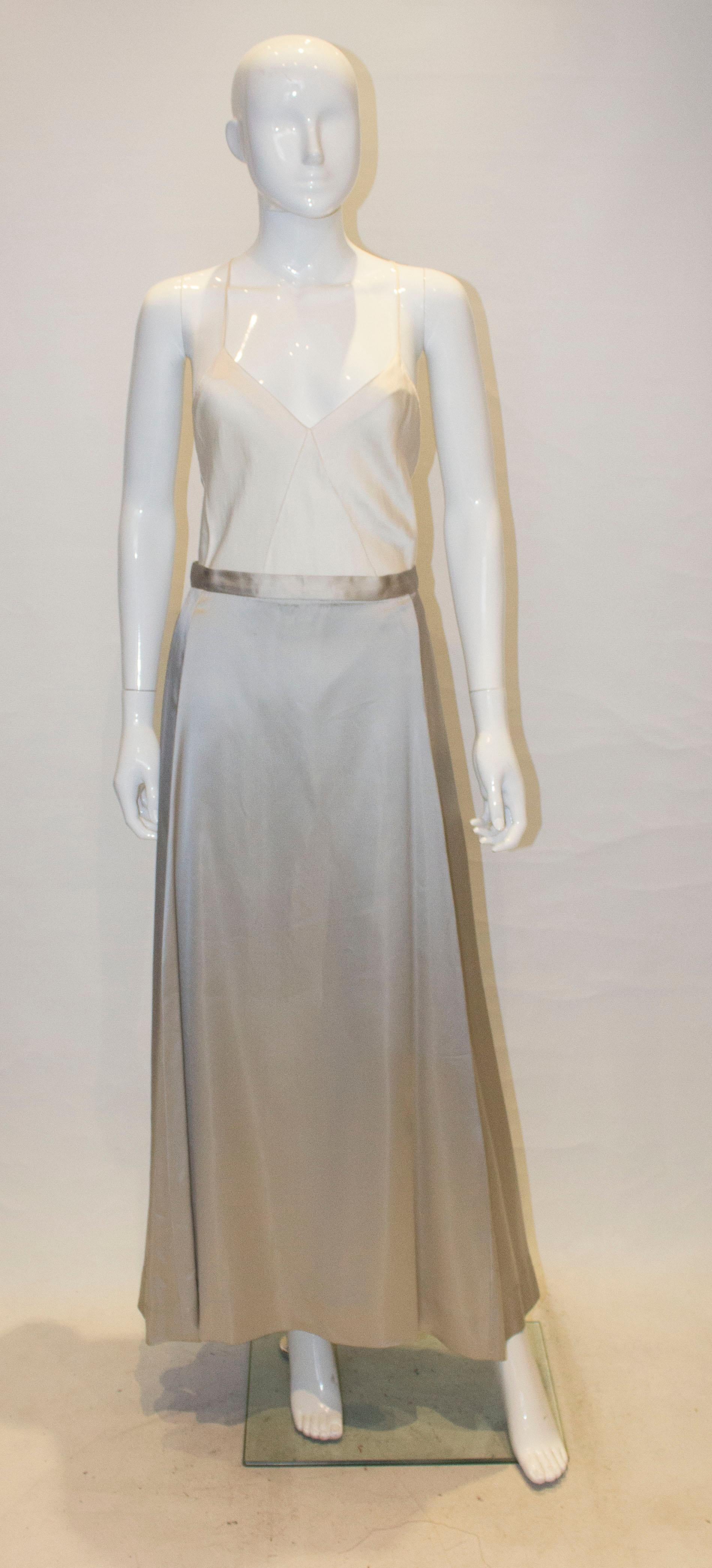 A pretty long skirt in a dove grey satin.  The skirt has a back central zip opening and is lined.
