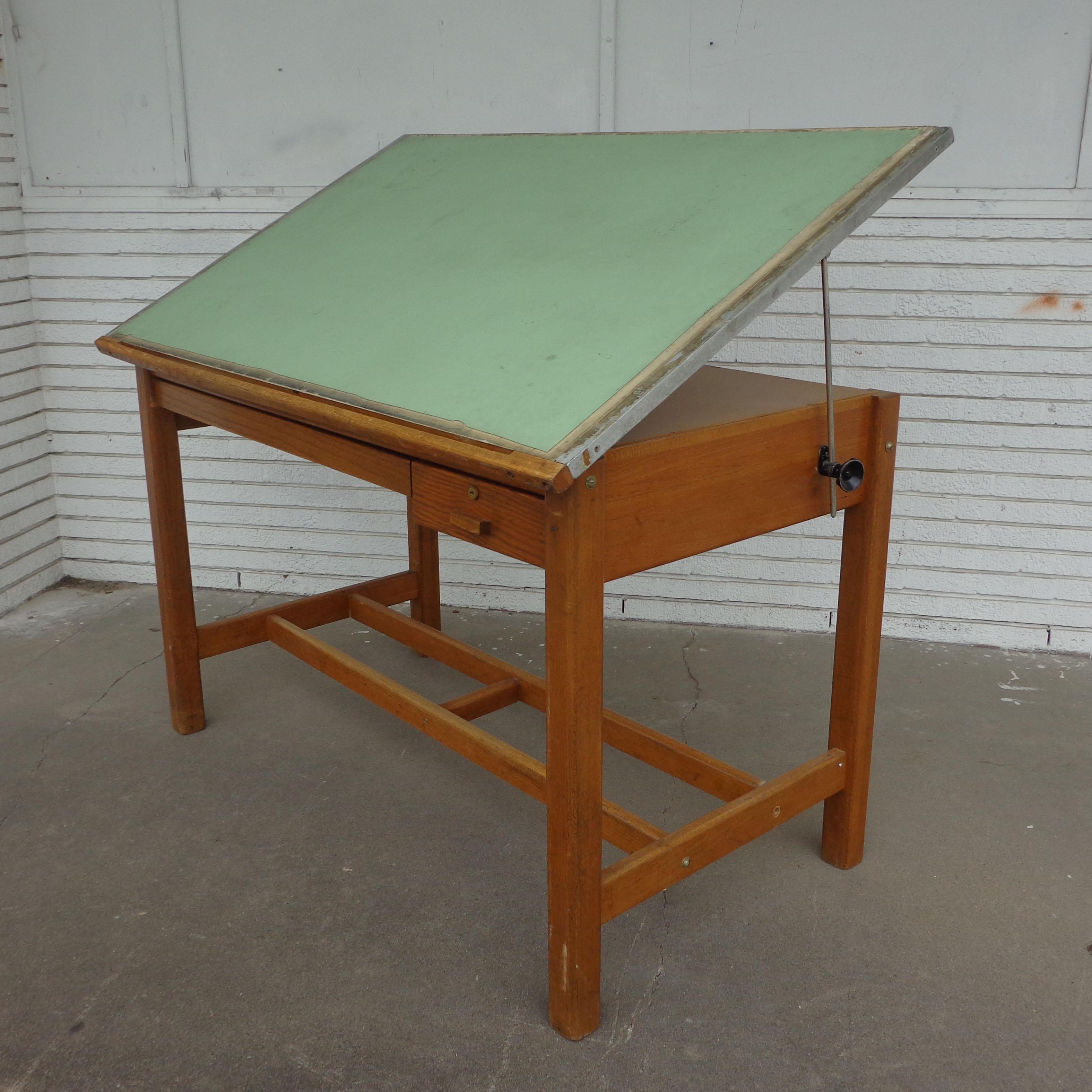 Vintage drafting table standing desk

Versatile mid century oak drafting table or standing desk.
Adjustable top featuring two drawers, one serving for drawing storage. 
 
