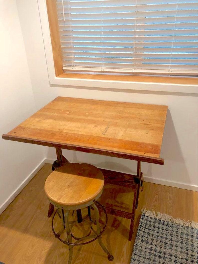 Vintage drafting table, wood and cast iron adjustable drawing table with stool,
This wood and cast iron drafting desk is not in perfect condition. It has been lovingly used.