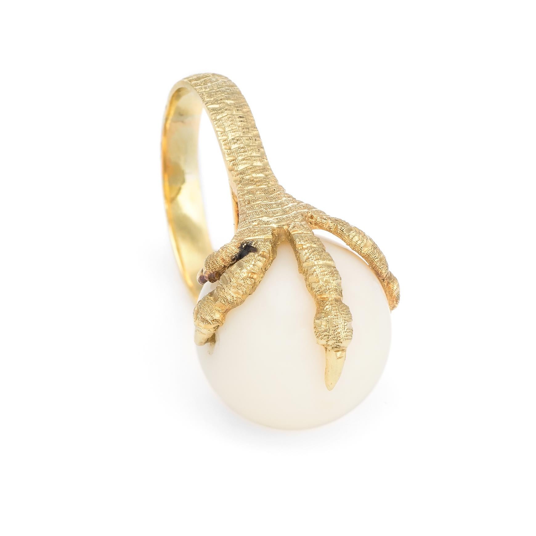 Distinct & stylish vintage dragons claw cocktail ring (circa 1960s to 1970s), crafted in 18 karat yellow gold. 

The angel skin coral orb measures 16mm. The coral is in excellent condition and free of cracks or chips. 

The dragons claw features