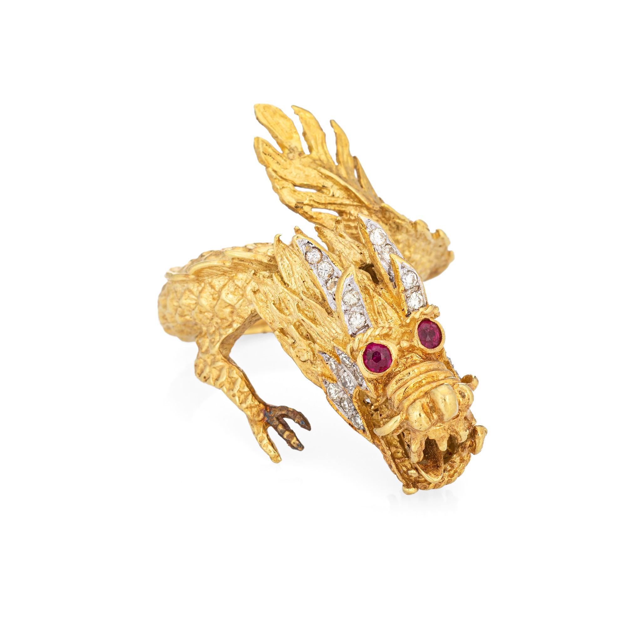 Unique & stylish vintage dragon ring (circa 1960s to 1970s) crafted in 18 karat yellow gold. 

24 diamonds total an estimated 0.12 carats (estimated at I-J color and SI1-I1 clarity). Two rubies are set into the eyes.  

The elaborate dragon features
