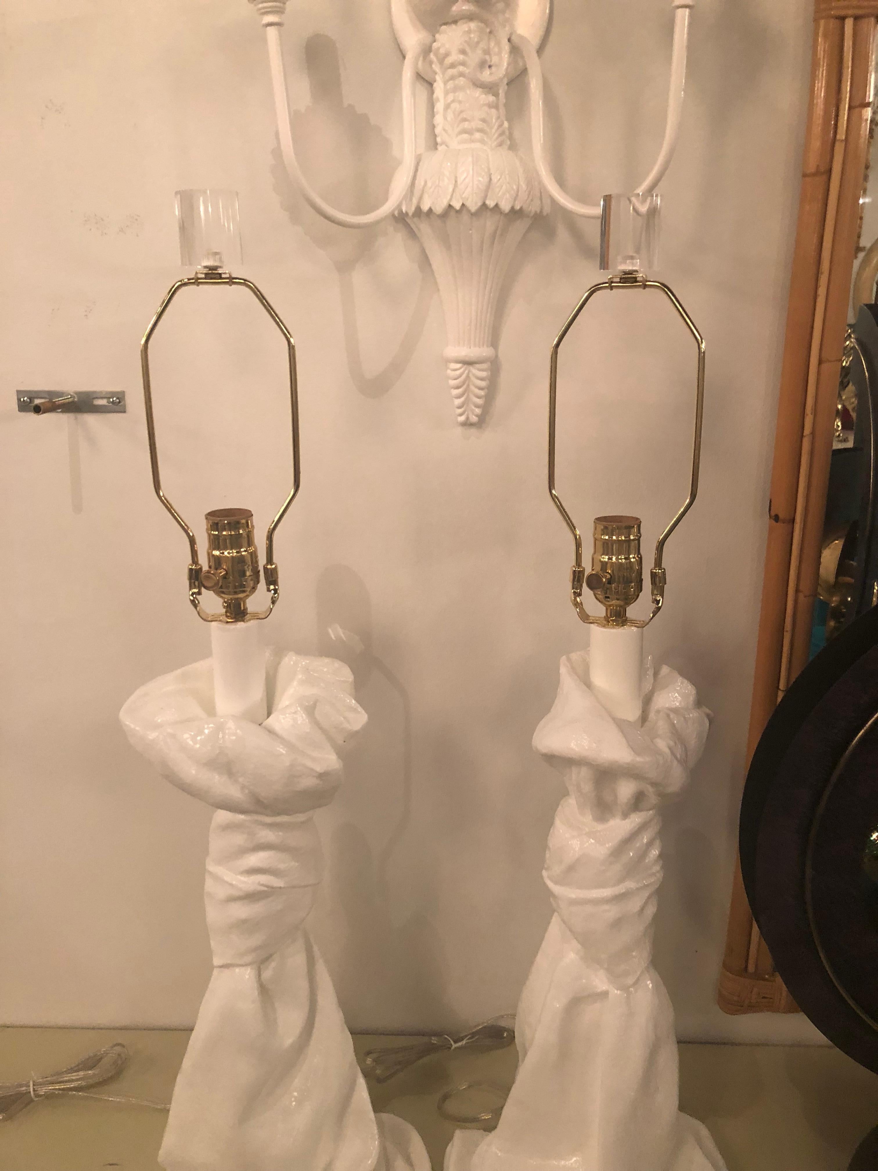 Beautiful vintage pair of John Dickinson style plaster draped table lamps. These have been meticulously restored in a white lacquer finish, all new brass hardware, new wiring, Lucite finial.
