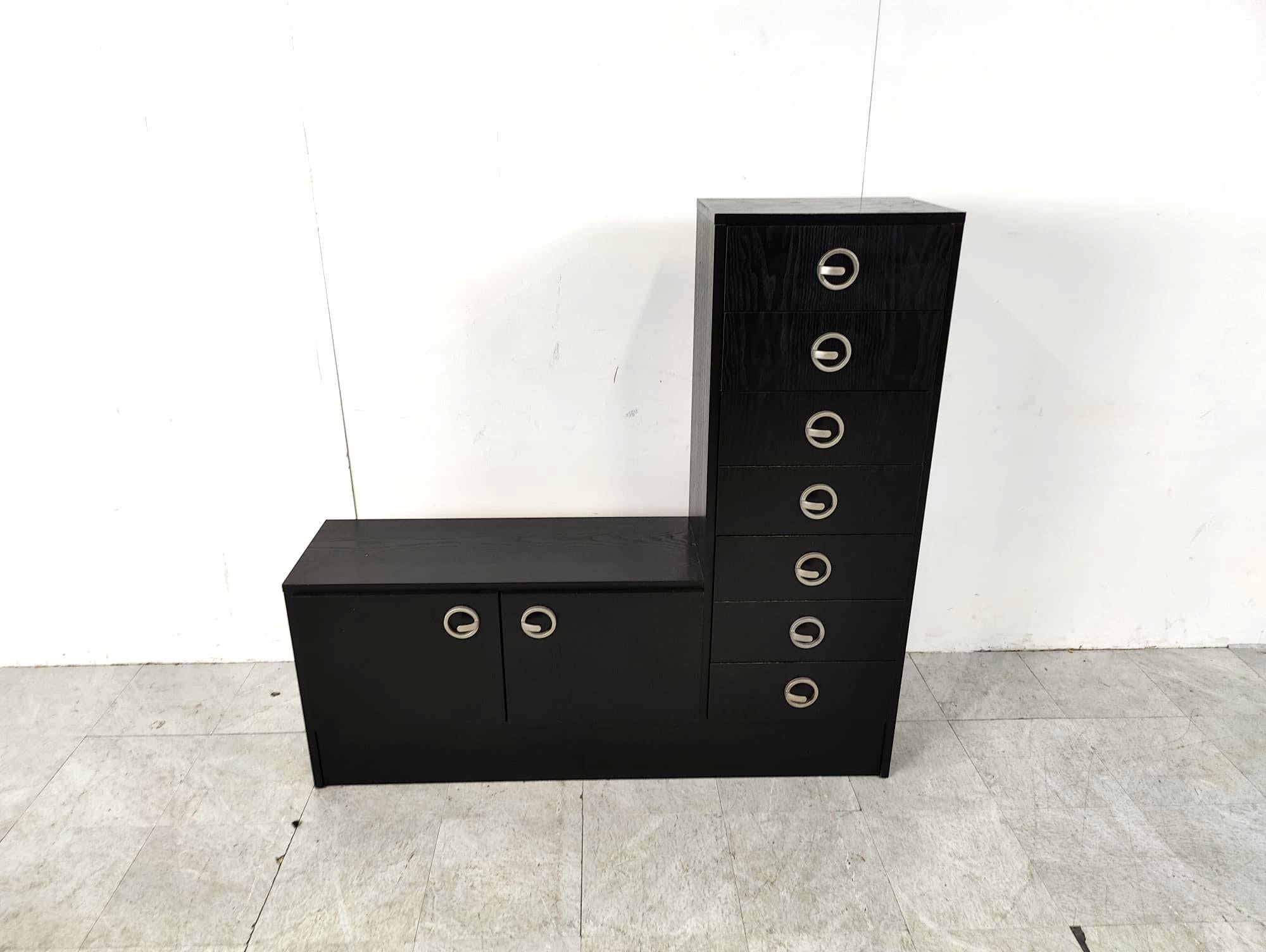 Vintage black wooden cabinet with two doors and 7 drawers.

The cabinet has some nice handles.

Ideal storage cabinet for small clothing, shoes,...

1970s - Belgium

Dimensions:

Height: 125cm
Width: 130cm
Depth: 34cm

Ref.: 6425153