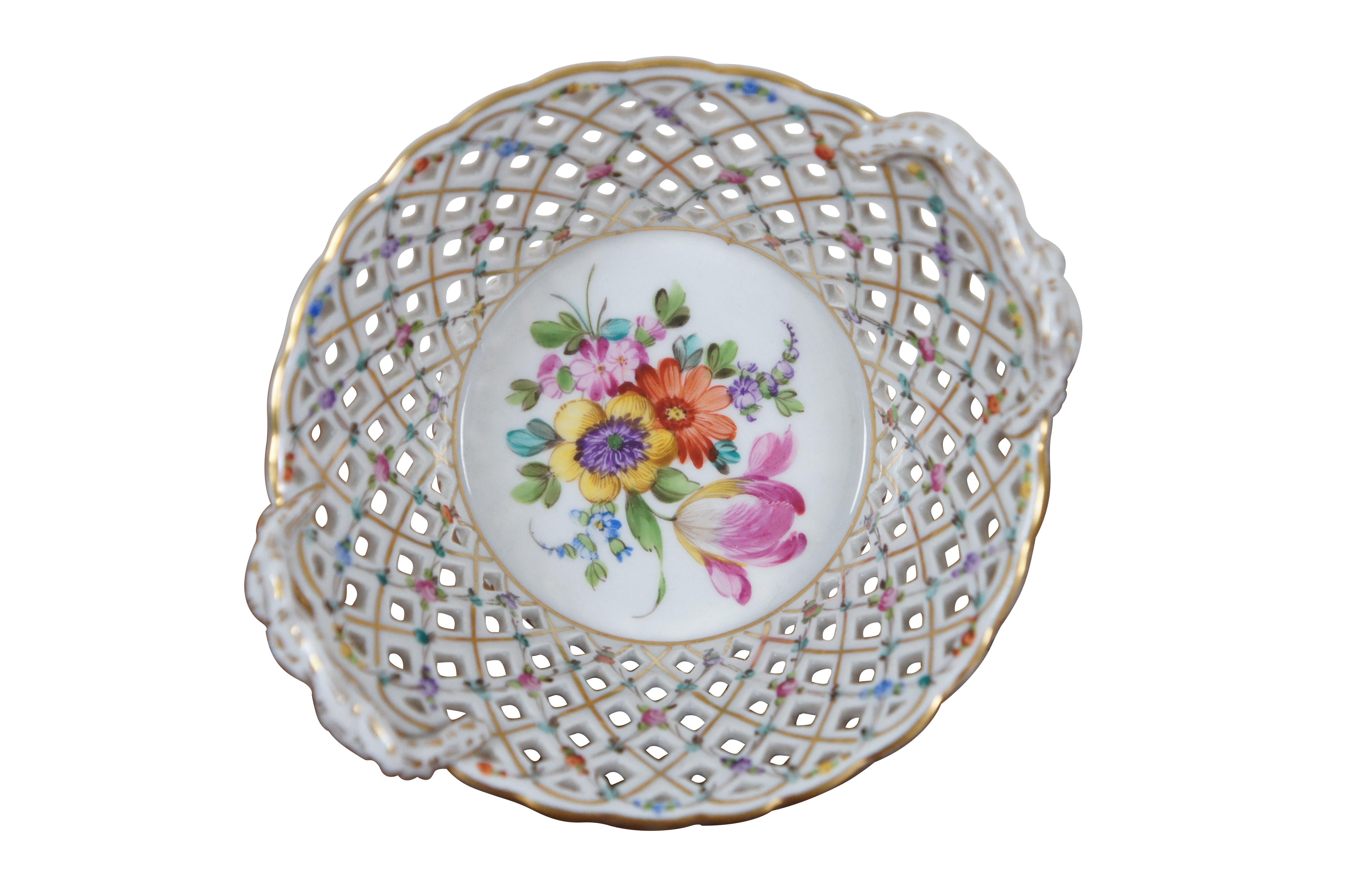 An exceptional Dresden basket weave hand painted bob bon dish or bowl.  Polychrome with colorful floral sprays and flowers throughout.

“The Sächsische Porzellan-Manufaktur Dresden GmbH (Saxon Porcelain Manufactory in Dresden Ltd), generally known