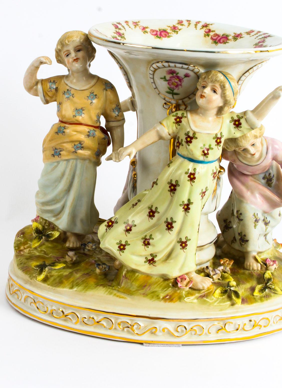 This is a thoroughly delightful Dresden Revival centrepiece, hand-painted and dating from the mid 20th century.
 
It is beautifully hand-painted with an array of bright floral colours and with absolutely fantastic attention to detail. It features