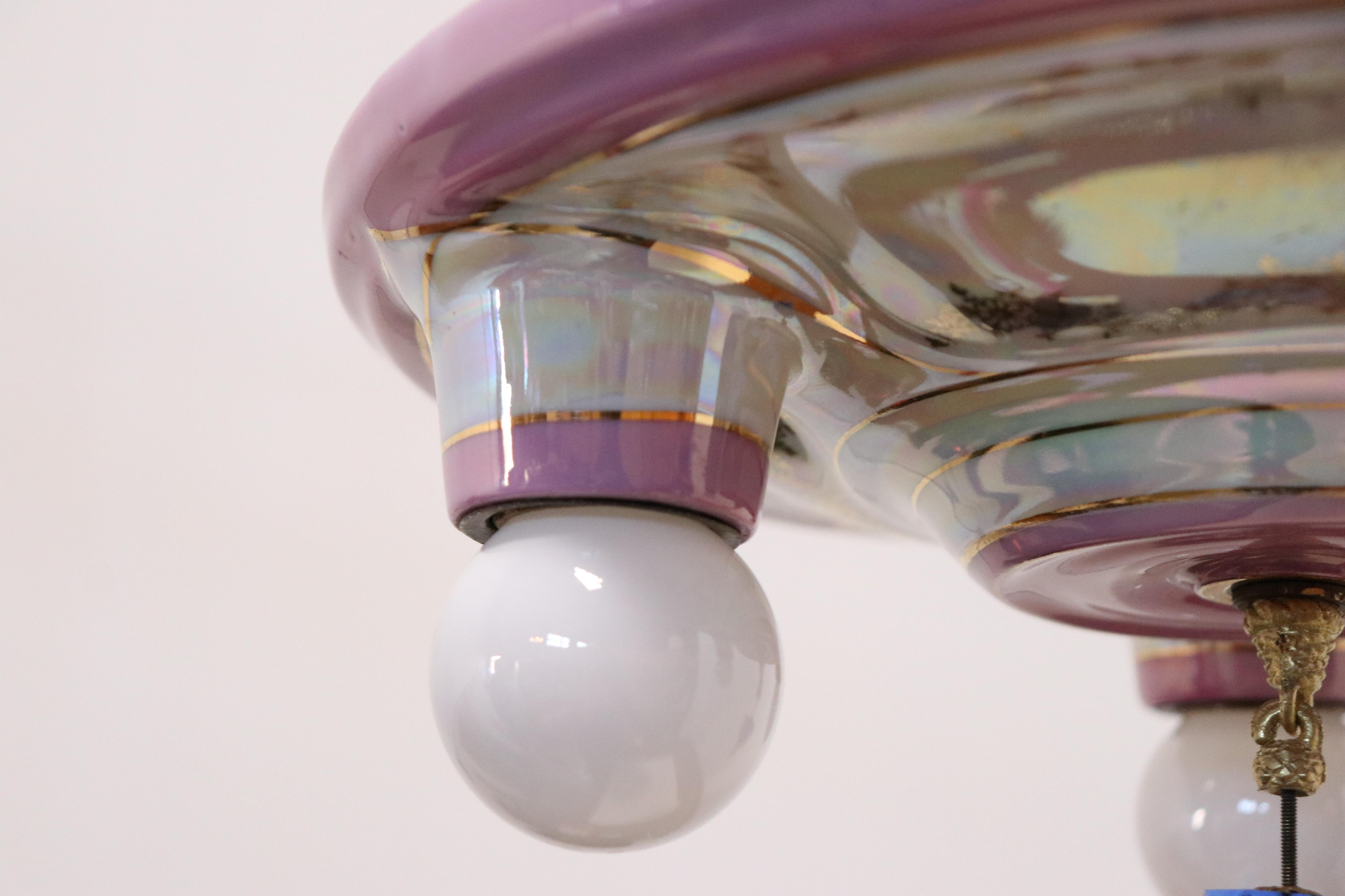 A vintage Dresden style three-socket flush mount light fixture.

Features a white and pink Lustreware style finish with finial pendant. 

Made for hardwire installation.