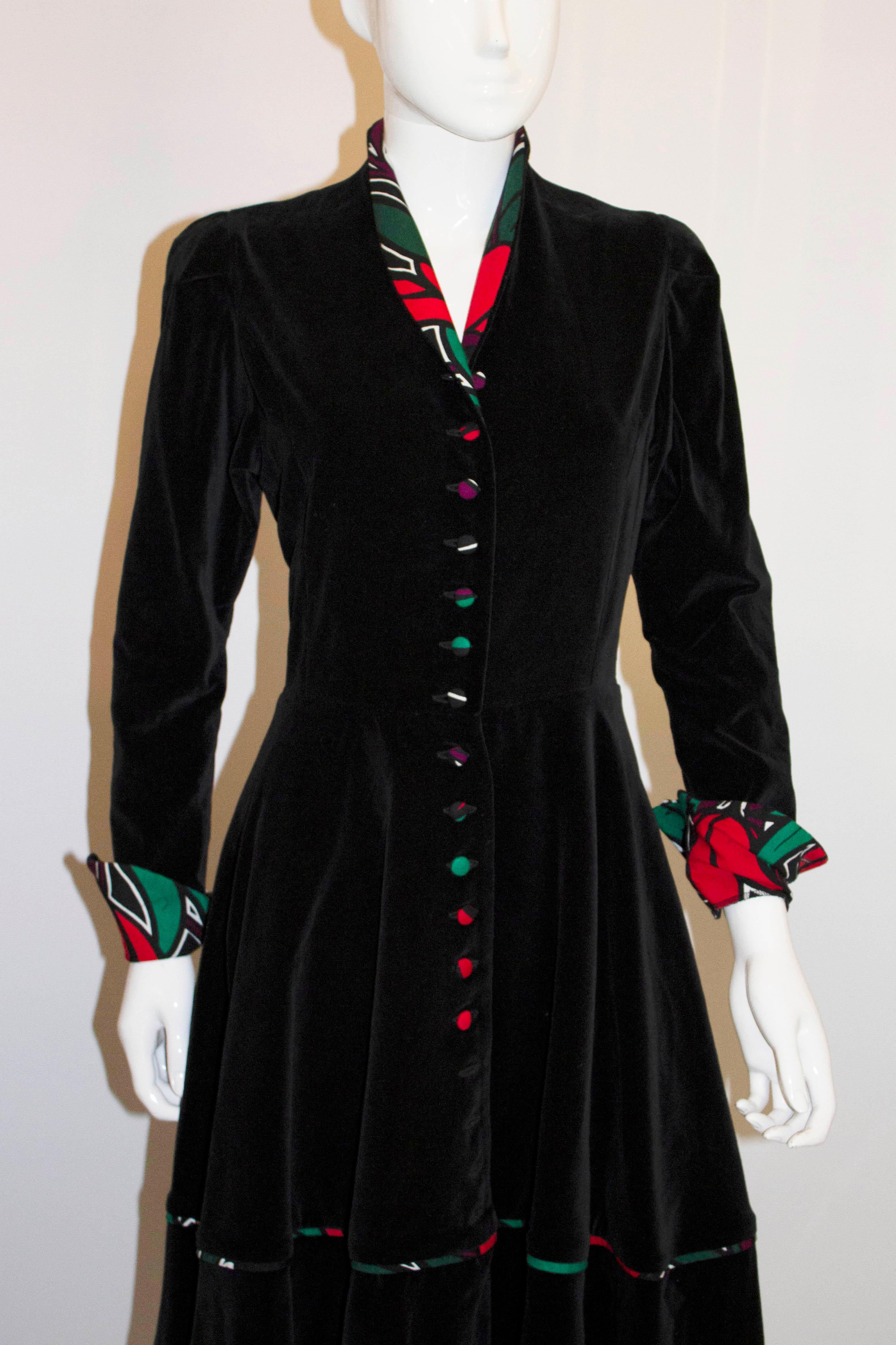 A stunning vintage dress by Angela Holmes for Droopy and Browns. In black velvet with wonderful buttons and lining, the dress has a shawl collar, front button opening and great lining. The buttons could be moved 1 1/2'' to create more space!