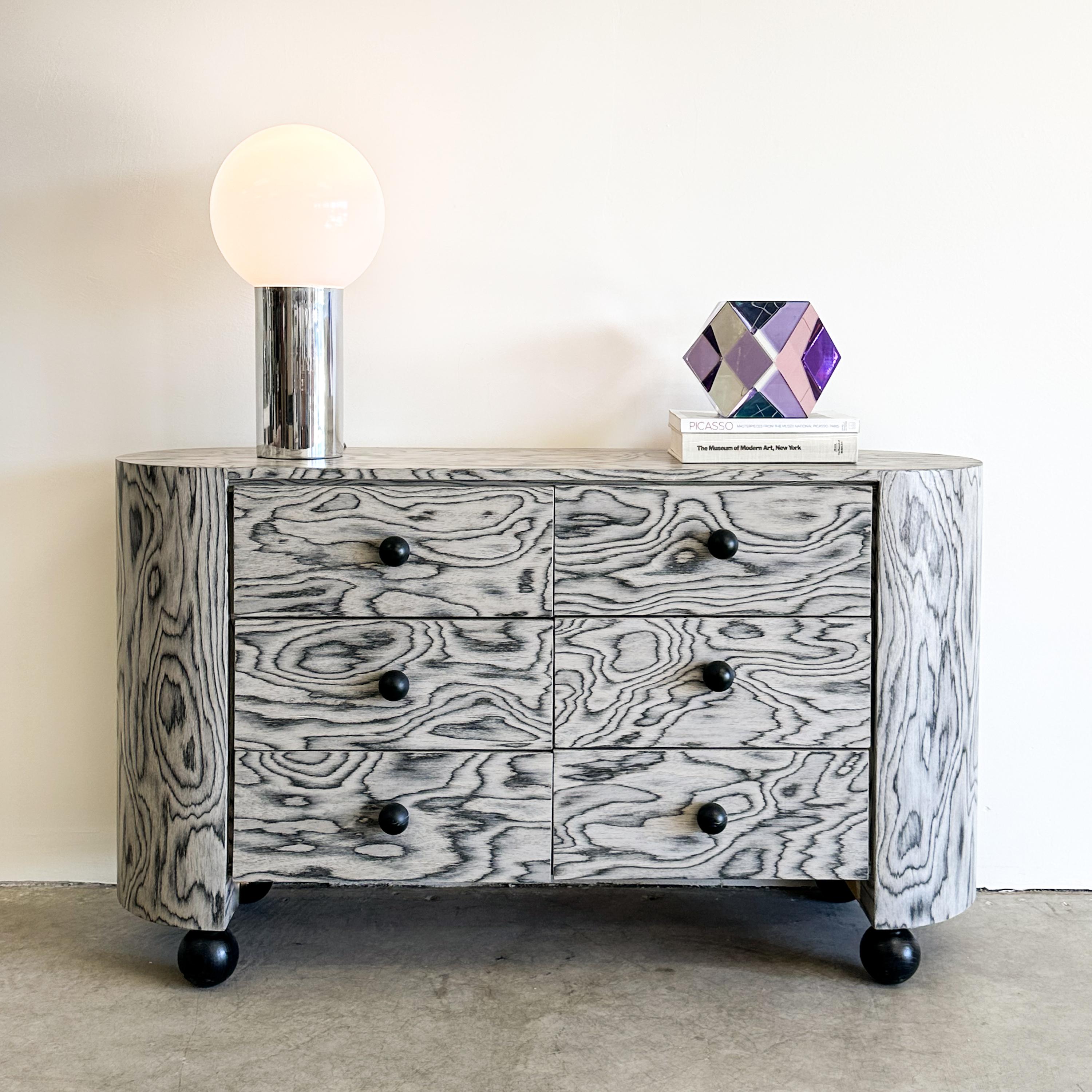 This vintage dresser features re-veneering with the original ALPI veneer, designed by Ettore Sottsass in 1985 an iconic figure in the Memphis design movement. Its distinctive veneer has been sealed with a satin finish to enhance durability. The